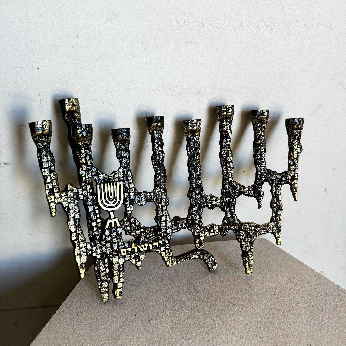 Vintage Israeli Brutalist Brass Menorah with raw textures, menorah emblem, and Hebrew inscriptions. A bold, timeless piece for Chanukah or display.
 
 We sell items as acquired, without restoring or repairing. Vintage pieces may have age-related