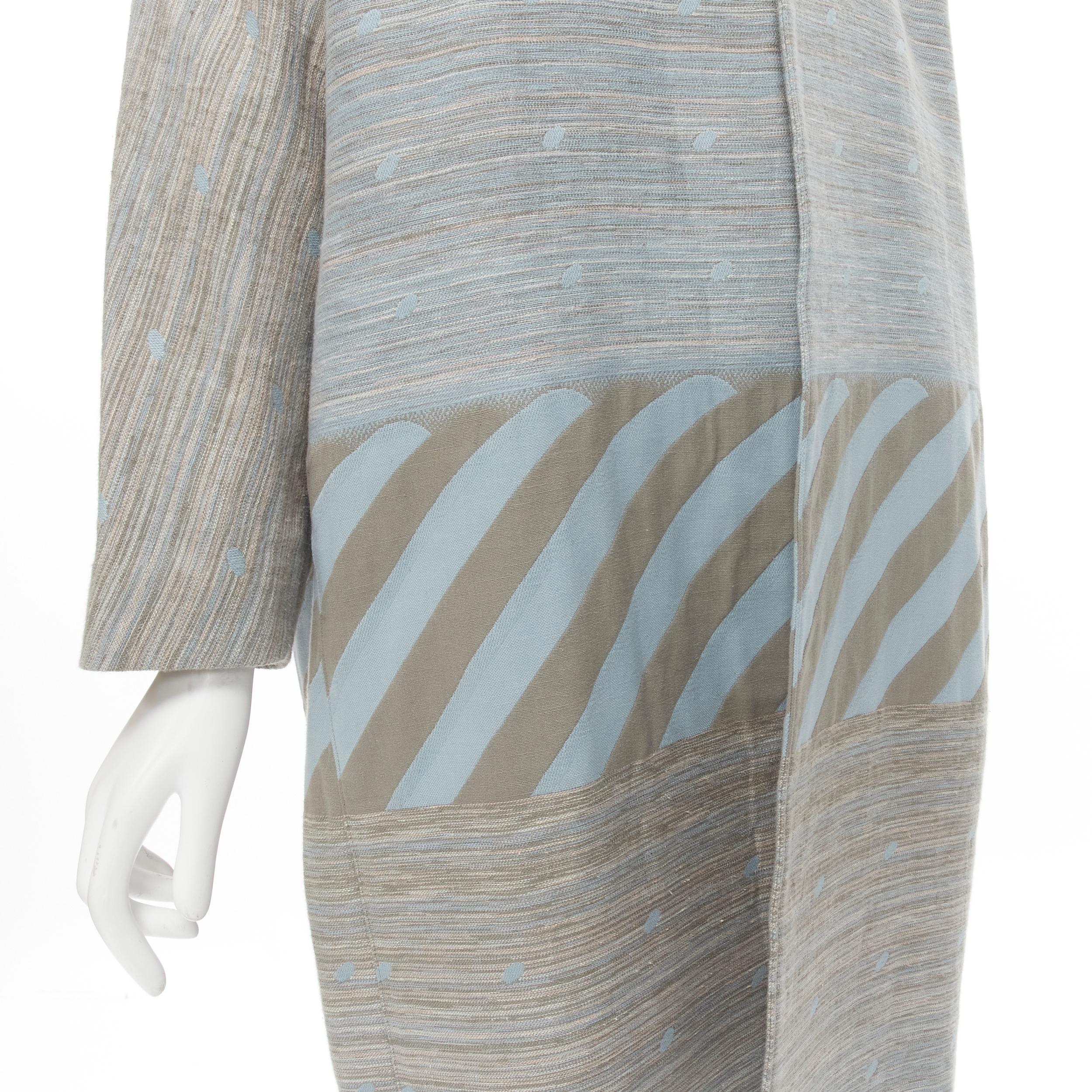 vintage ISSEY MIYAKE 1980's grey sky blue geometric stripe jacquard cocoon coat M 
Reference: CRTI/A00469 
Brand: Issey Miyake 
Collection: 1980's 
Material: Cotton 
Color: Grey 
Pattern: Striped 
Extra Detail: Twisted seam from neckline down