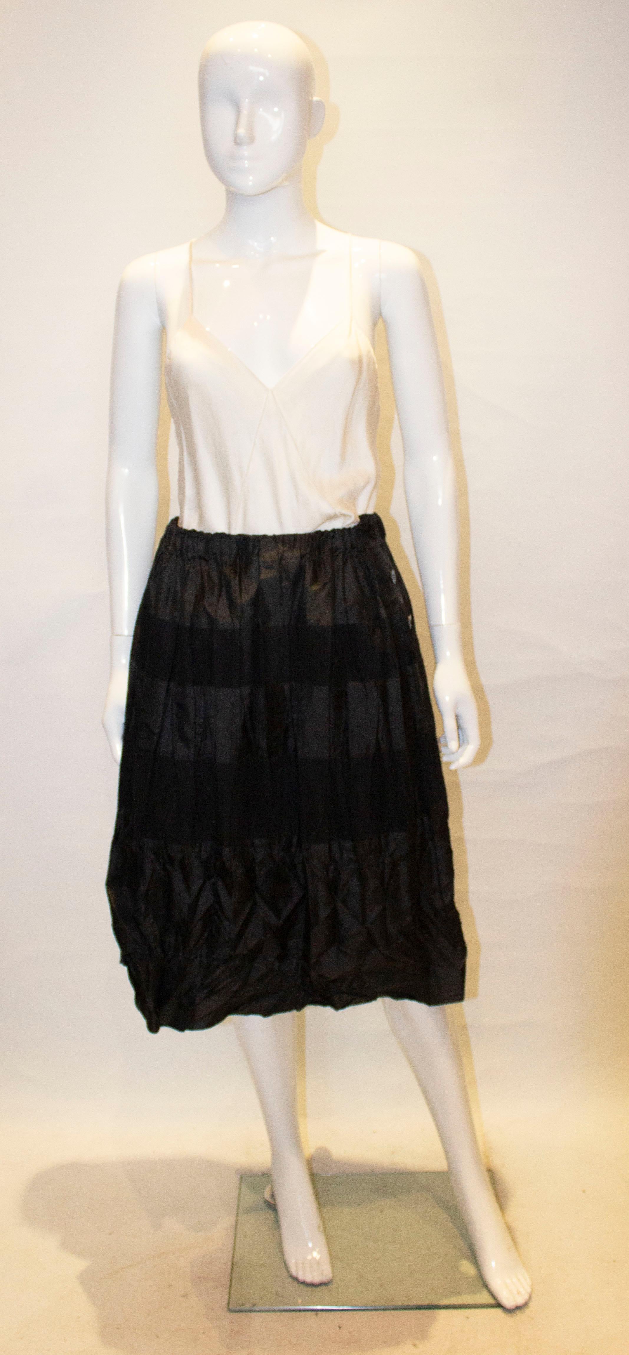 A chic and easy to wear vintage skirt by Issey Miyake.  The skirt has a three button side opening and horizontal bands of fabric. Label number lm94 -fg 918.