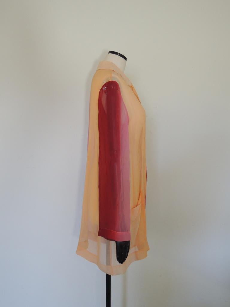 This is a vintage long sleeve sheer top, presumably silk though not tagged as such, from Issey Miyake in shades of pink, orange and red.

I believe the fabric is silk but cannot say definitively.

The size and content tags have been removed.

This