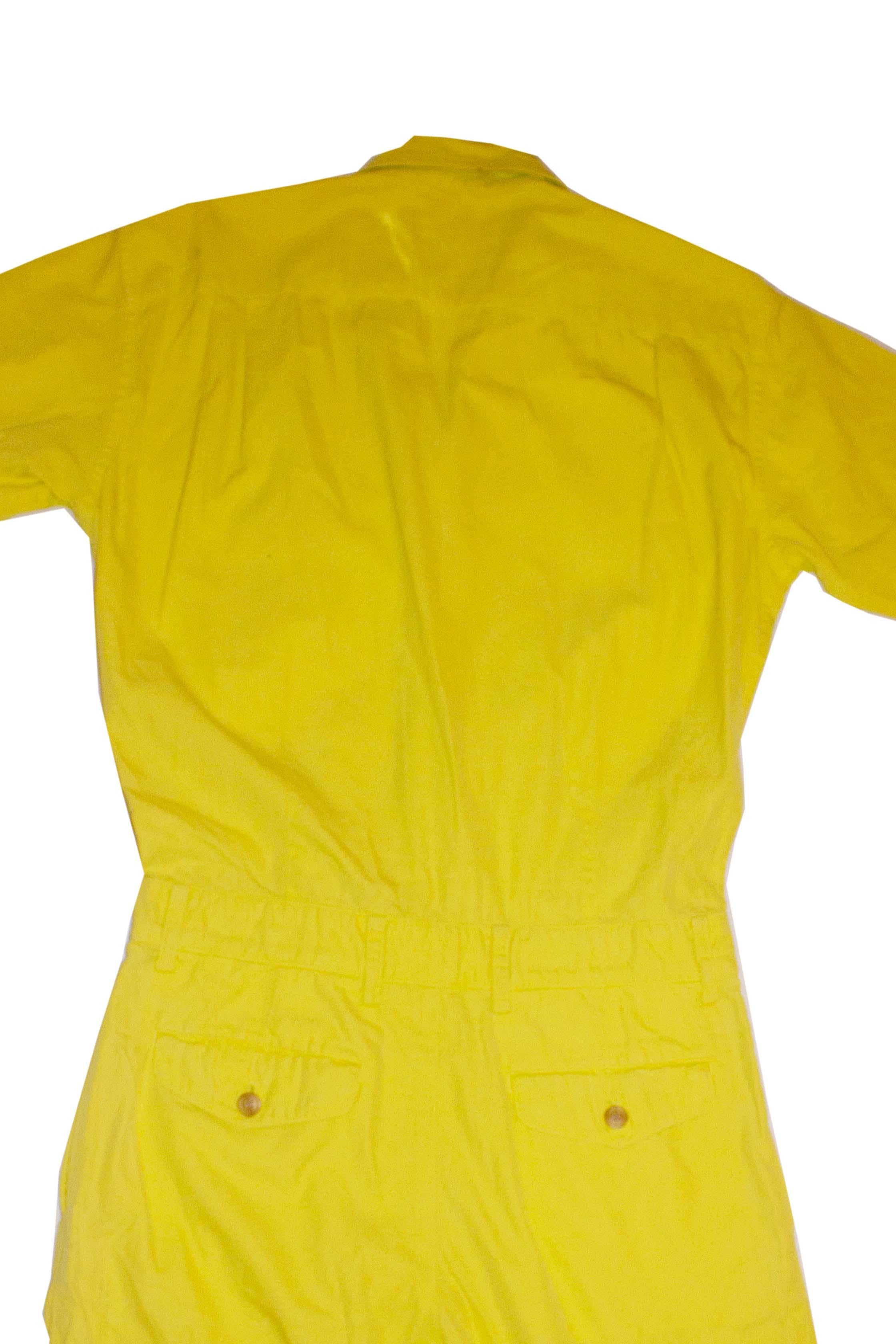 A headturning vintage cotton jumpsuit  by Issey Miyake mens line. In a yellow cotton, the jumpsuit has short sleaves , left hand side chest pocket, button fly, belt hoops,  and a pocket on either side. 
ME91 - F1640 Measurements: chest 44''. waist