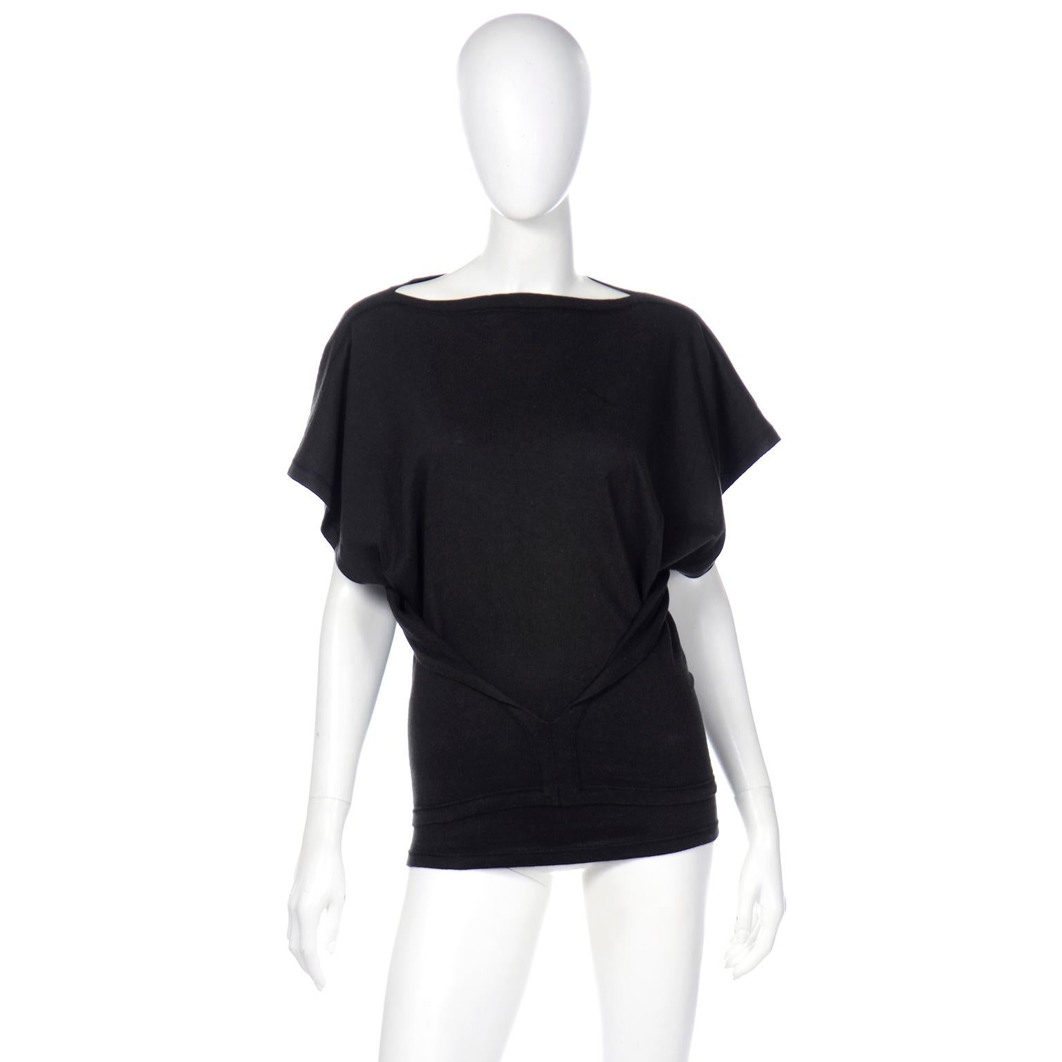 This is a very unique Issey Miyake vintage top in a washed black cotton with the Plantation label. This great top has bat wings with short square cut sleeves that drape really well when worn. There are cutouts on the sides and two closed panels