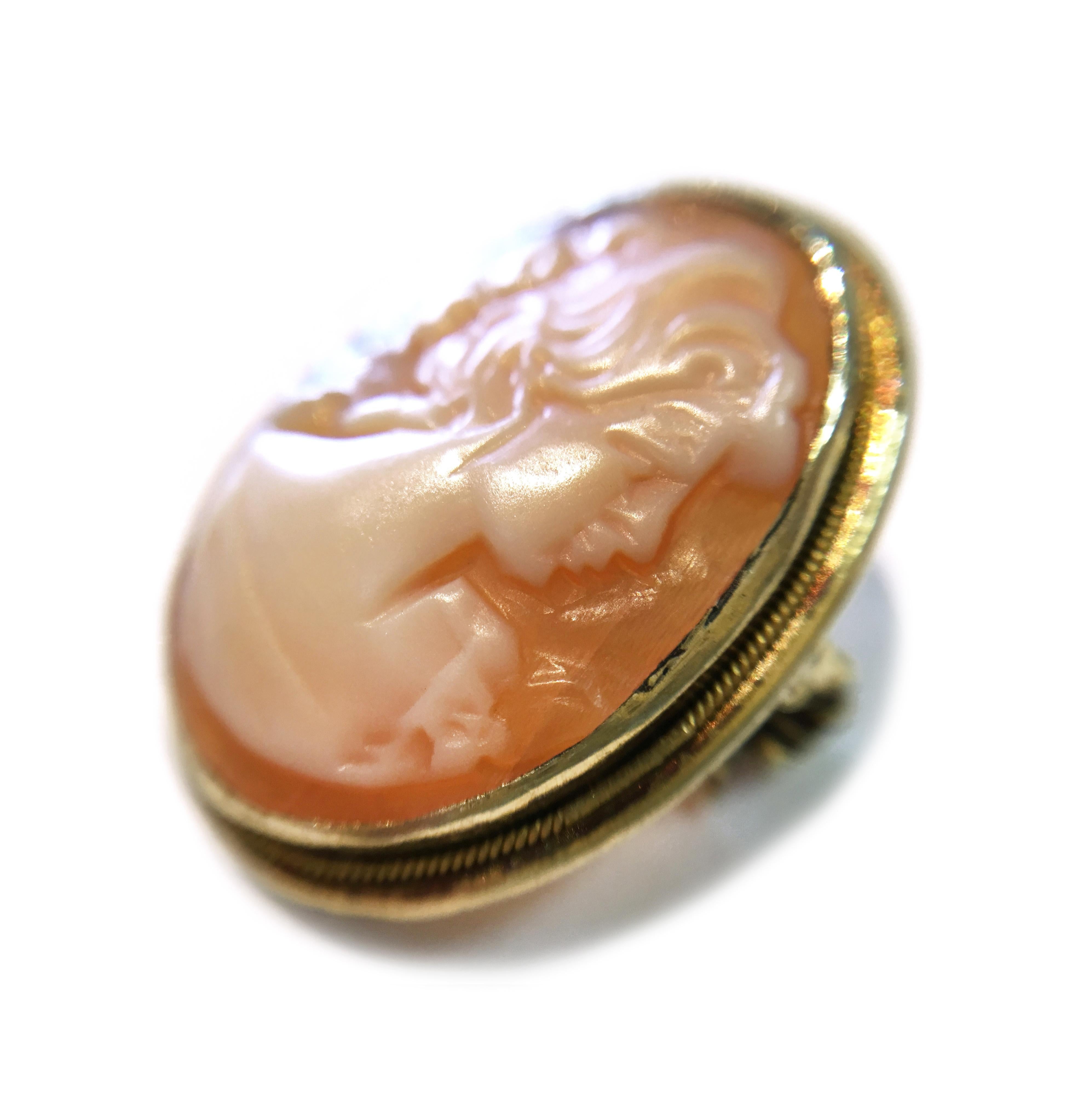 Vintage Italian 14 Karat Small Shell Cameo Brooch. Portrait of a lady with a flower on her collar. This is a petite yet lovely cameo that will work well as an accent piece to your favorite outfit. There is gold bezel with a milgrain all around the