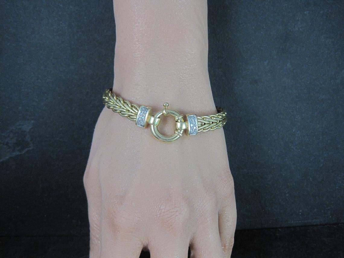 This gorgeous estate bracelet is solid 14k yellow gold with white gold accenting and natural diamonds.

Bracelet Specifics:
14 Round Diamonds - 0.14ctw.
Total weight - 21.3 grams
Chain - 8mm wide
7.5 inches long
Chunky nautical spring clasp.

Marks: