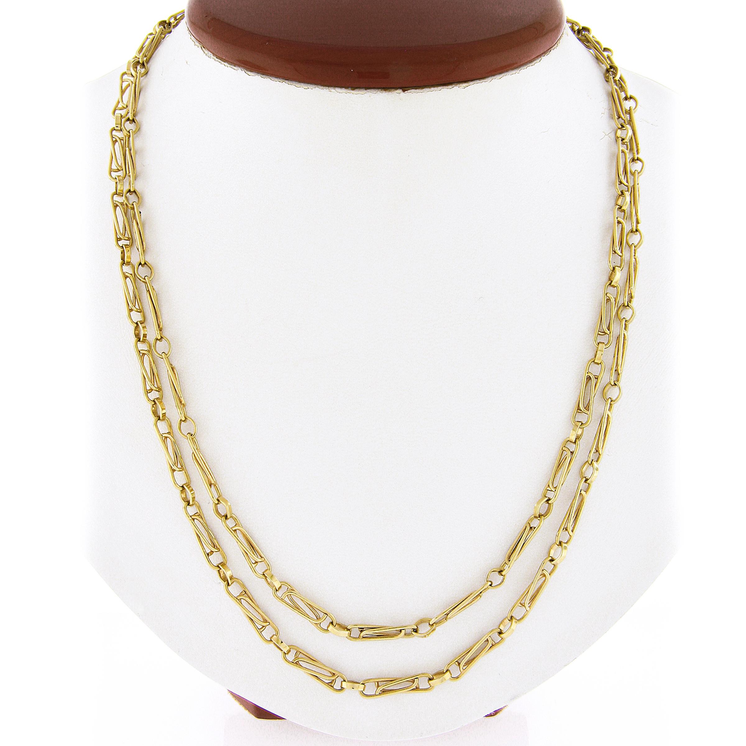 This vintage Italian link chain necklace was crafted from solid 14k yellow gold. It features a unique and fancy interlocking paperclip link design. The necklace is long at 40 inches which make it great for layering. The patina is preserved and it is