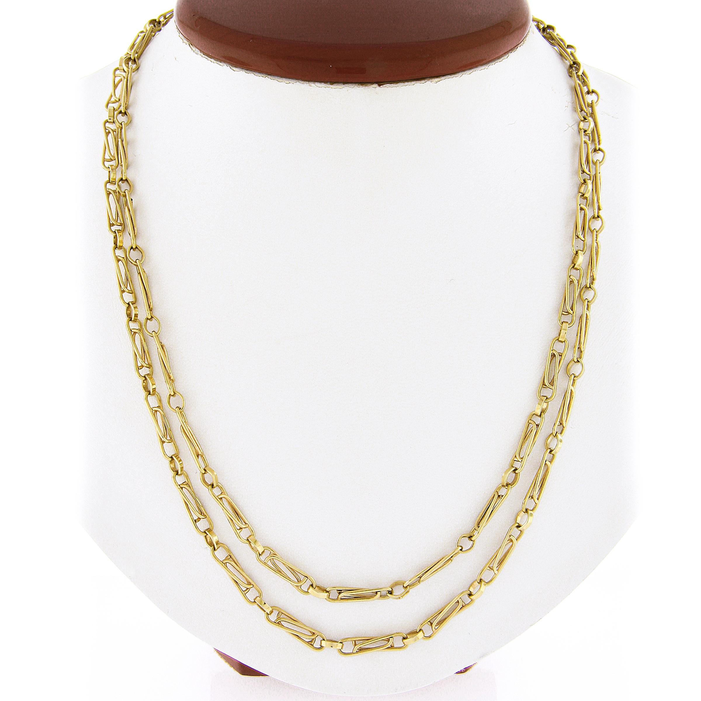 This vintage Italian link chain necklace was crafted from solid 14k yellow gold. It features a unique and fancy interlocking paperclip link design. The necklace is long at 40 inches which make it great for layering. The patina is preserved and it is