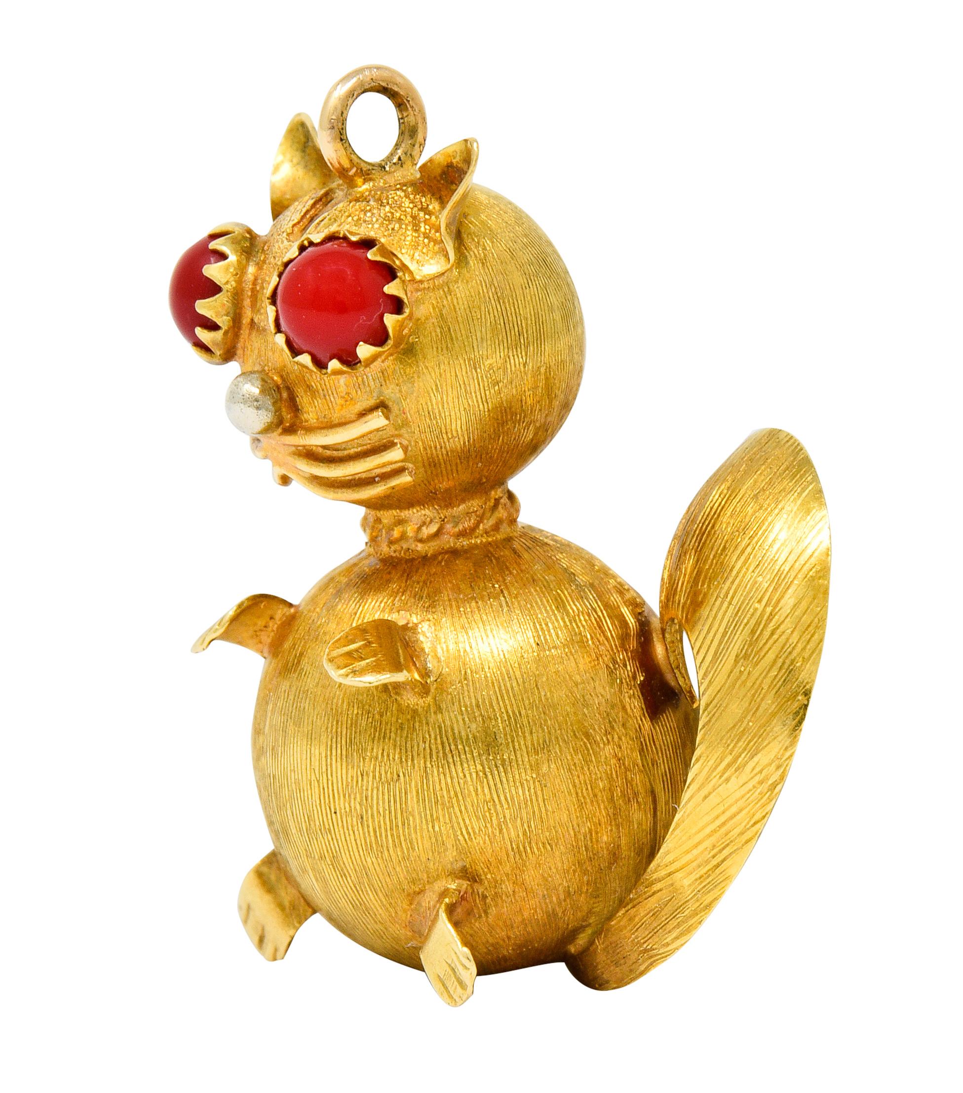 Designed as a stylized cat with a curled tail, polished whiskers, and cute paws

Featuring 4.0 mm red cabochon eyes and accented by a white gold ball nose

With a strong brushed finish

Completed by a jump ring bale

Stamped Italy and K-18 for 18