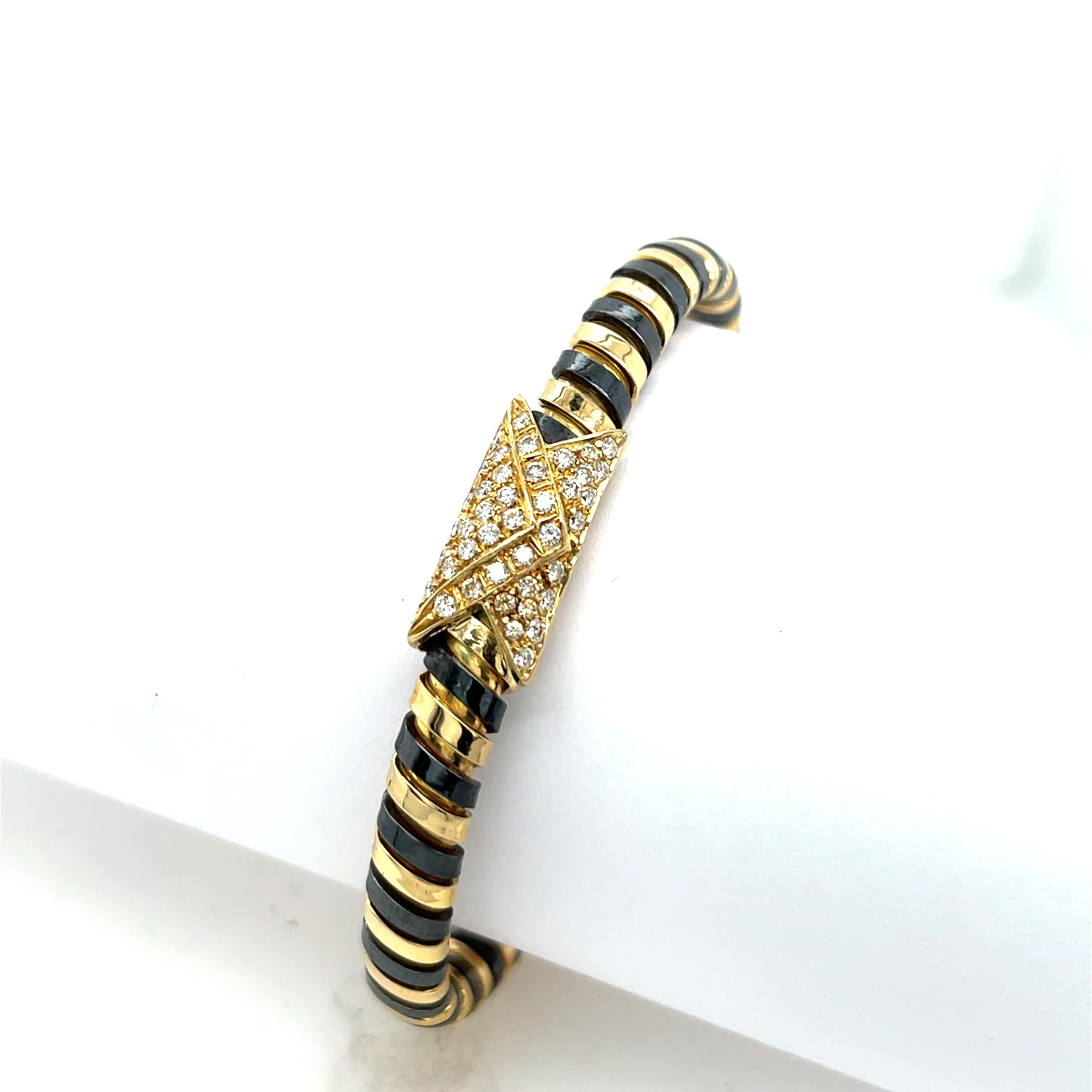 This vintage Italian bangle showcases a stunning combination of 18ct yellow gold and polished steel, 
blending elegance with modern craftsmanship. Adorned with natural diamonds 0.75ct in total for added brilliance, it offers a timeless design
