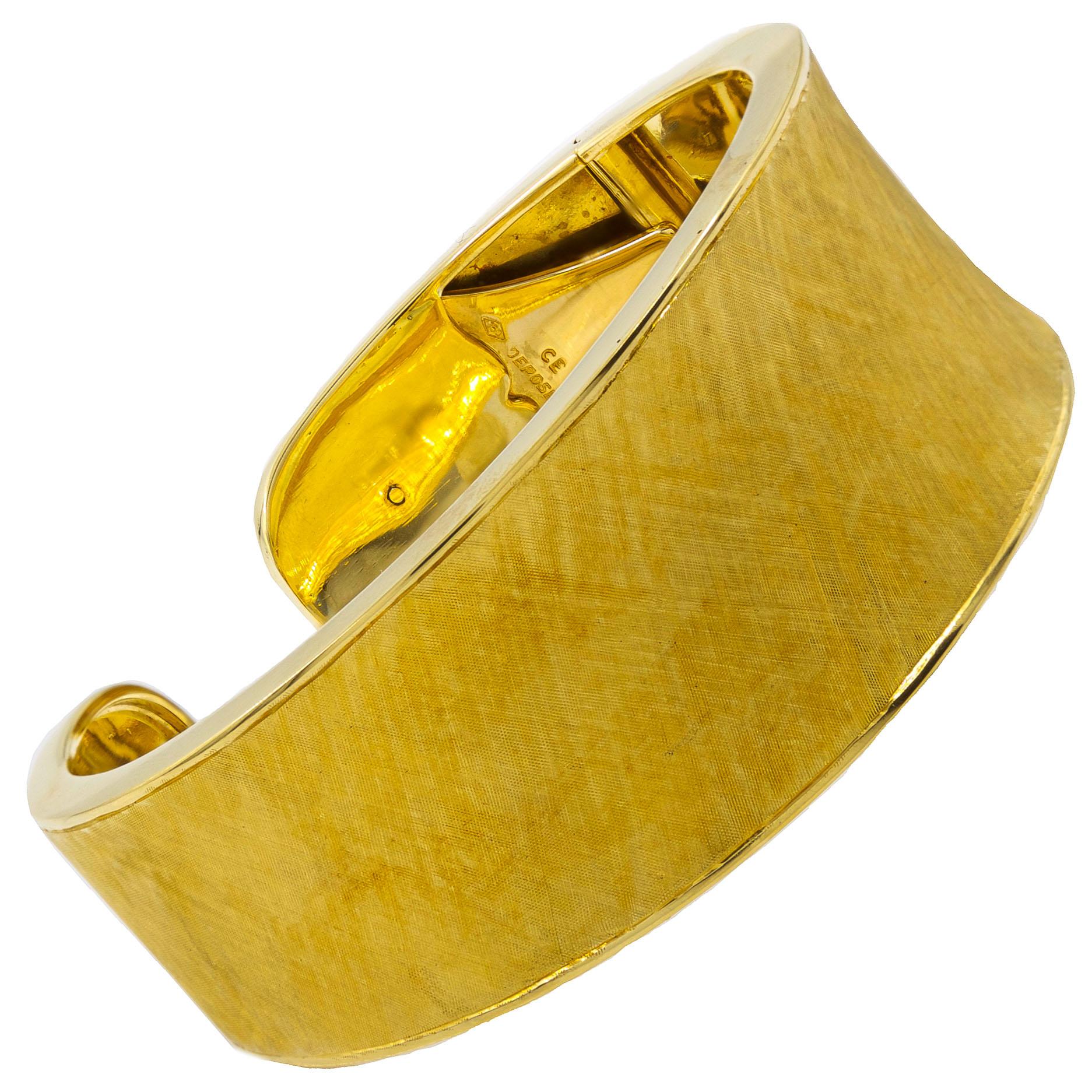 Understated and refined, this gorgeous cuff bracelet features a very clever locking hinge that allows it to easily be slipped onto the wrist before snapping the hinge closed. The surface is delicate with a pleasing cross-hatched brushed florentine