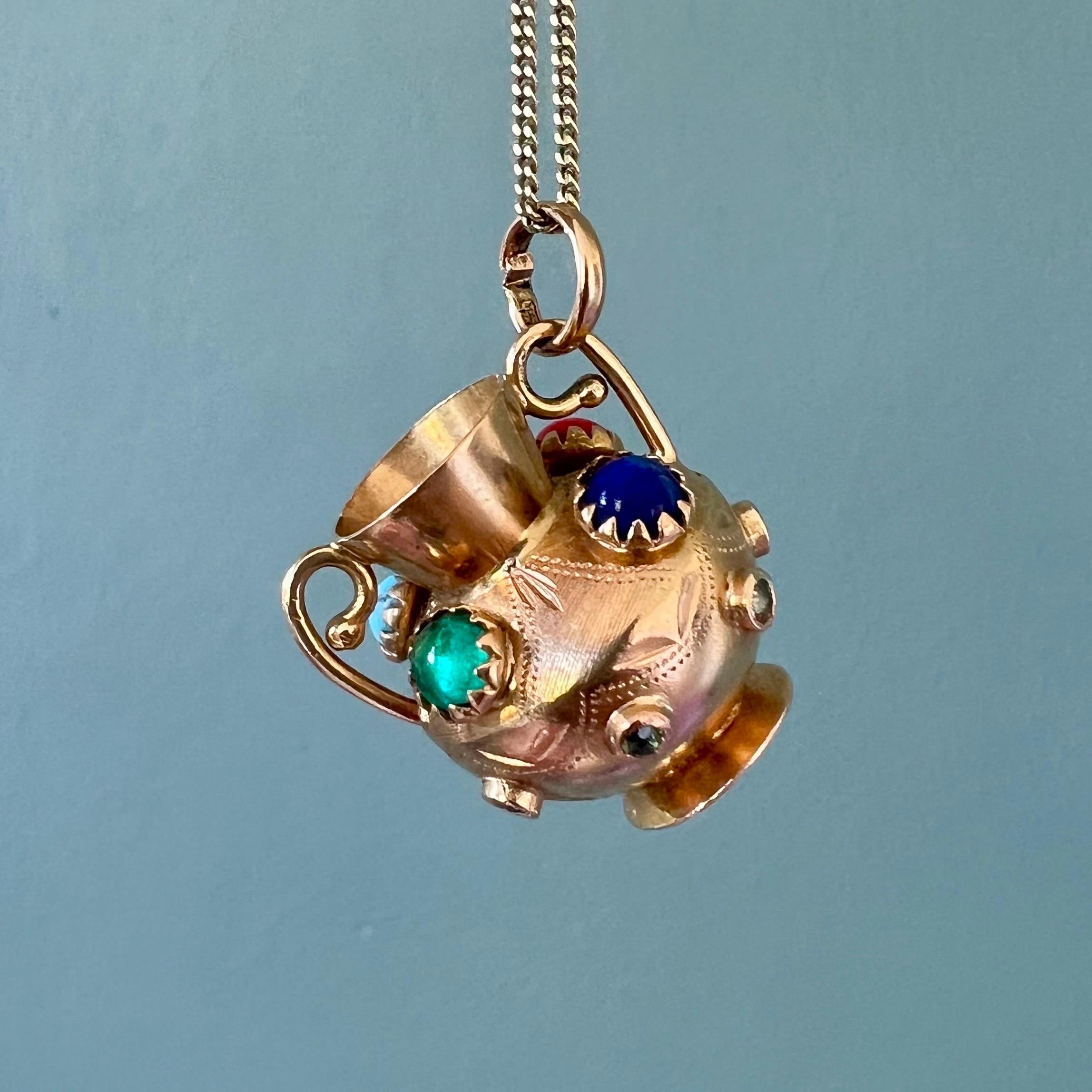 A lovely vintage Italian 18 karat yellow gold wide vase charm pendant adorned with fine colored stones. The charm is nicely modeled into a Greek-style vase and set with multi-colored stones on the surface of the vase body. The charm comes without
