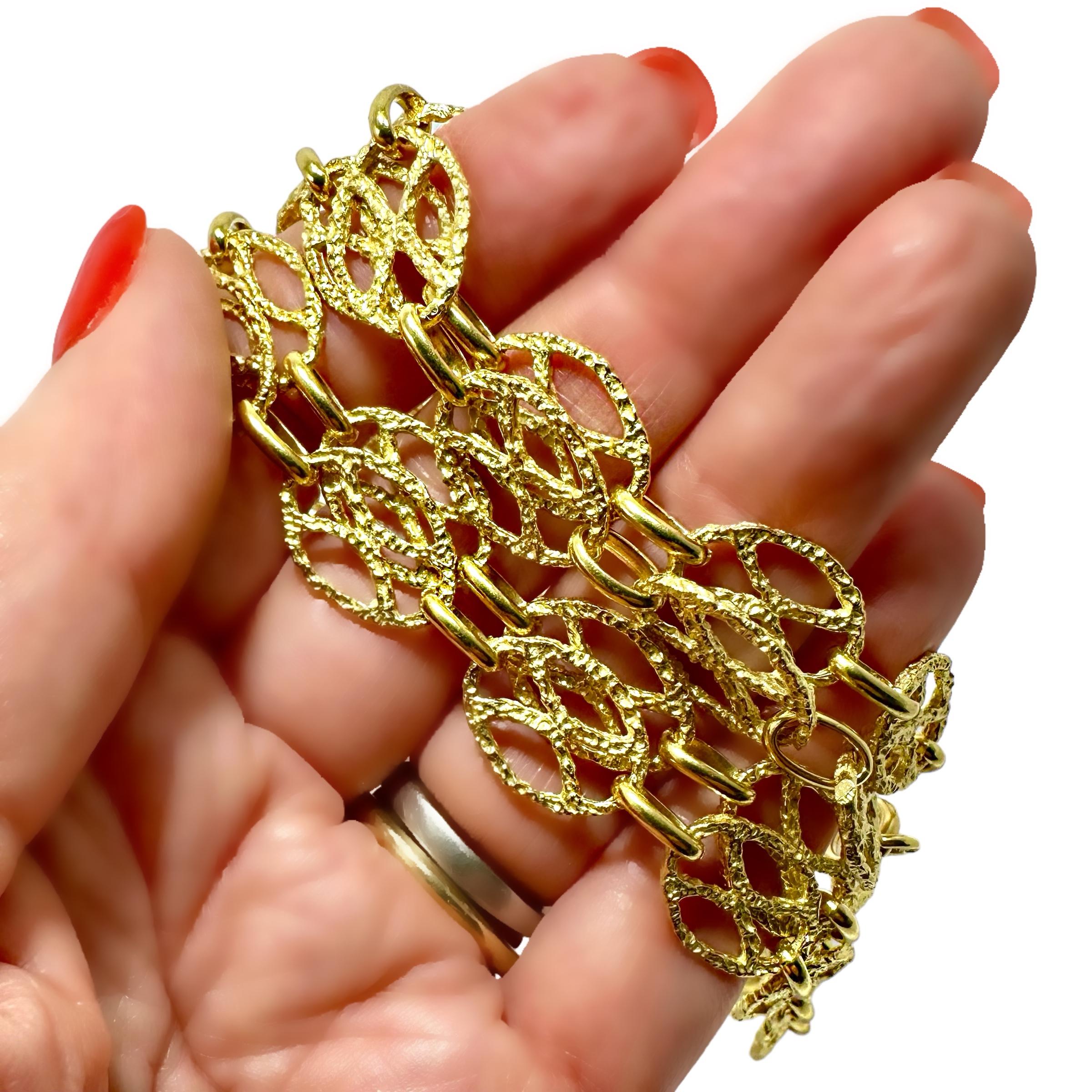 This wonderful Mid-20th Century 18k yellow gold hammered finish Italian necklace is comprised of one 37 inch of length of oval 