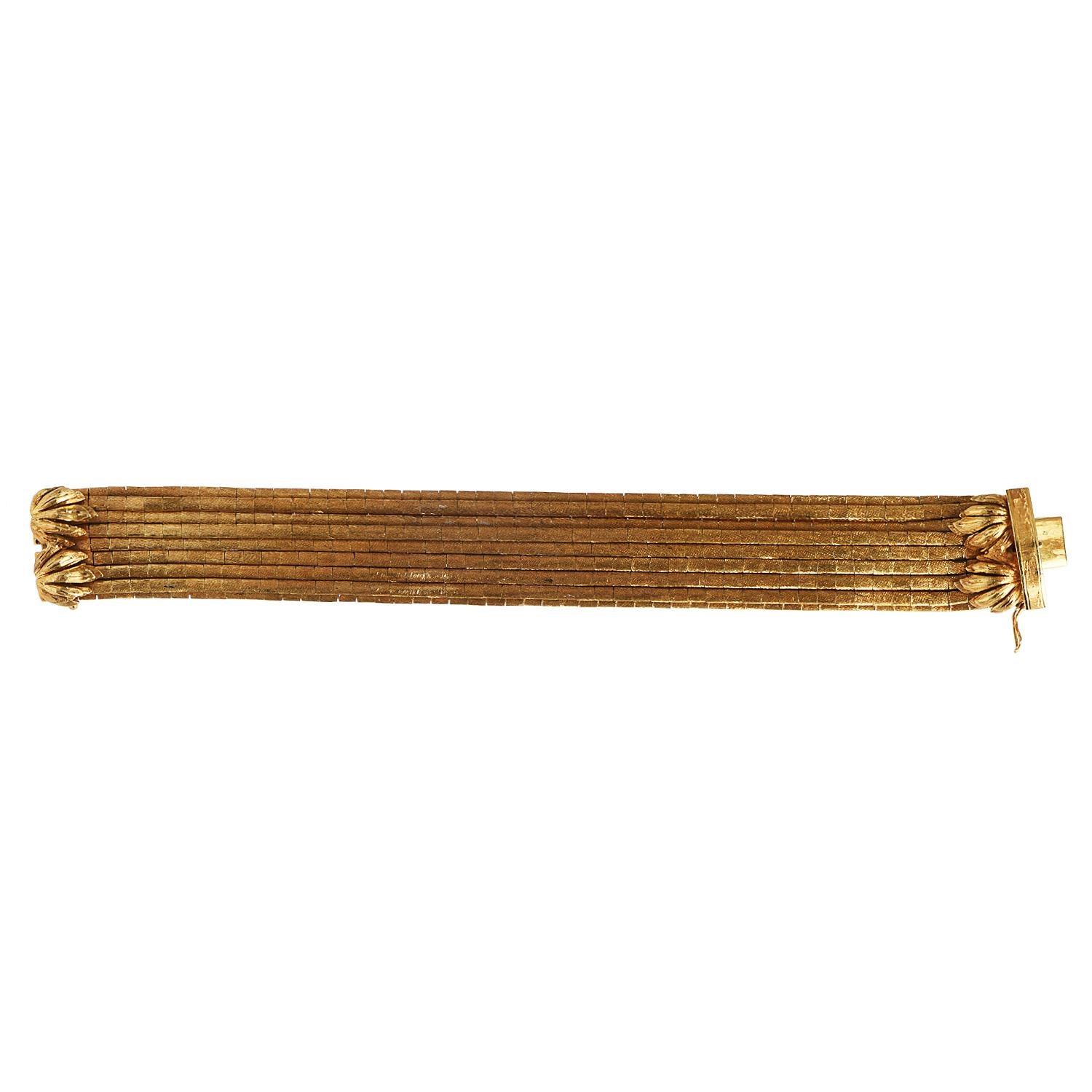 This incredibly sophisticated and versatile 1960s Vintage bracelet with barrel bamboo style link is crafted in 18K yellow gold.

weighting in total 109.4 Grams.  It is composed of fifteen strands of gold.

Measuring appx. 7.25
