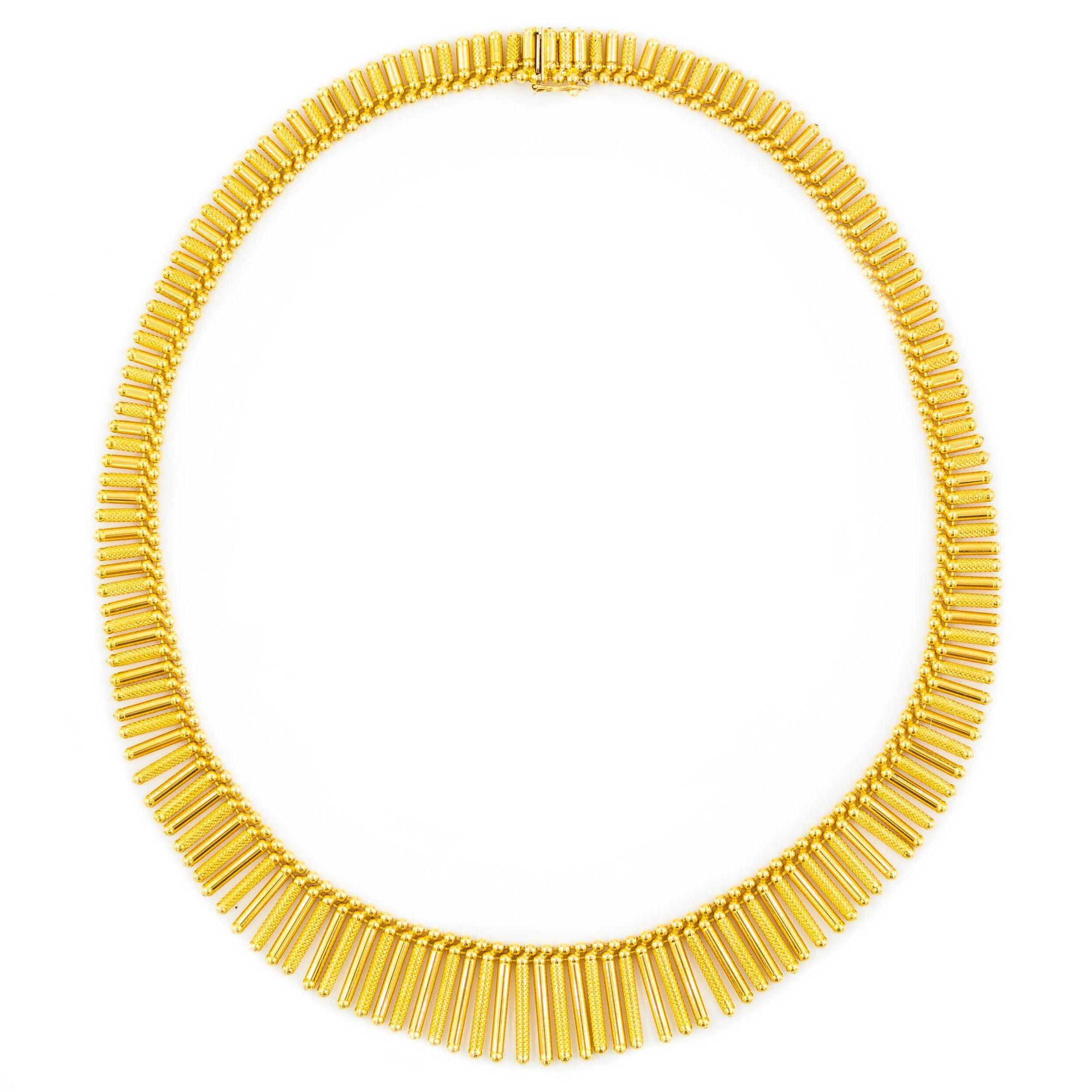 A wonderful slinky form by the well-known Italian jeweler Uno-A-Erre, it features a series of alternating textured and high-polish tubes with spherical ends hung in a fringe that graduates from 3/4