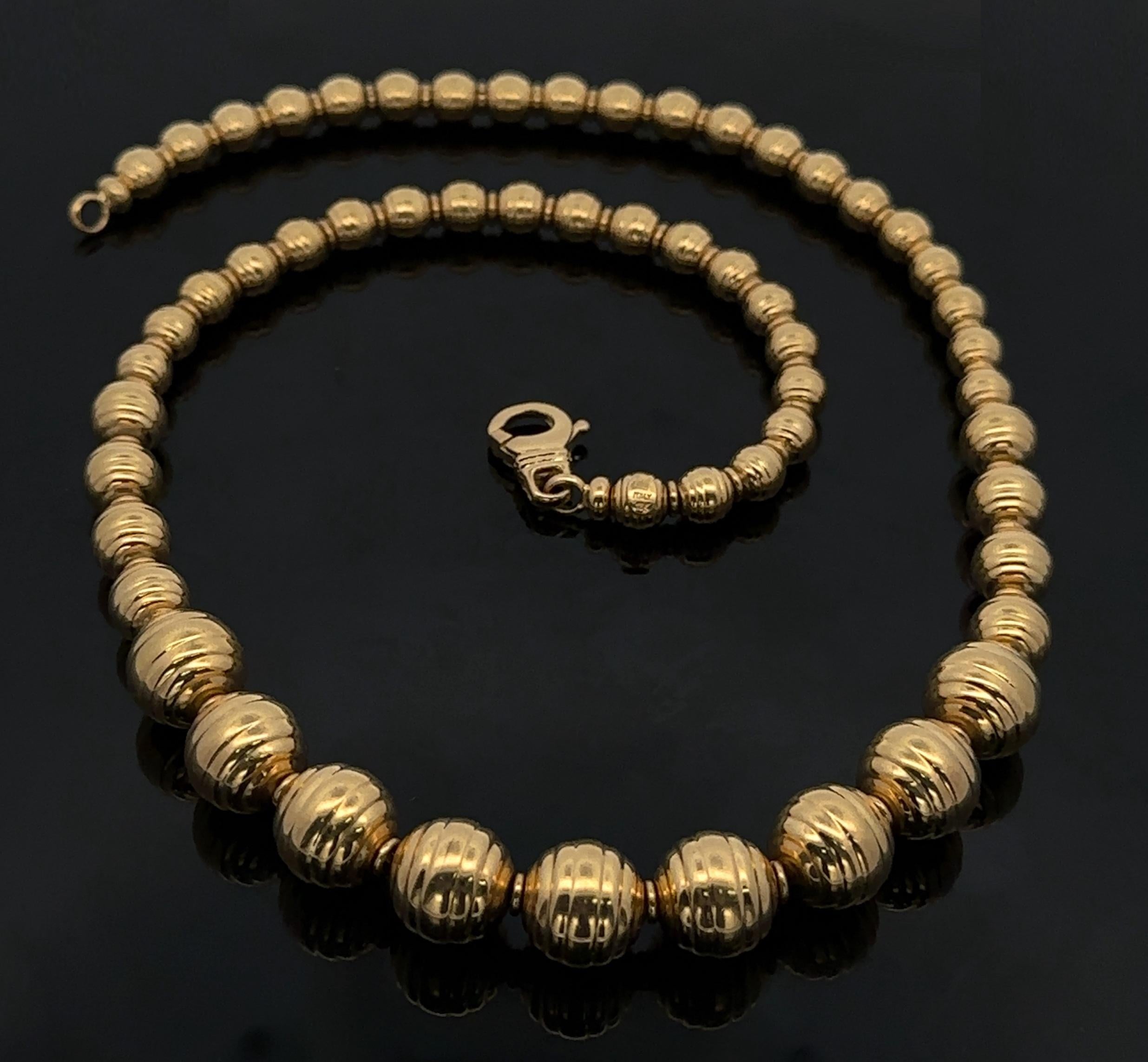 Material: 18K Yellow Gold
Weight: 43.53 Grams
Necklace Type: Graduated Grooved Round Ball Bead on Box Link Chain
Necklace Length: 18 Inches
Closure: Lobster Claw Clasp
Bead Thickness: Graduated from 4.5mm to 10.9mm
Condition: Original finish &