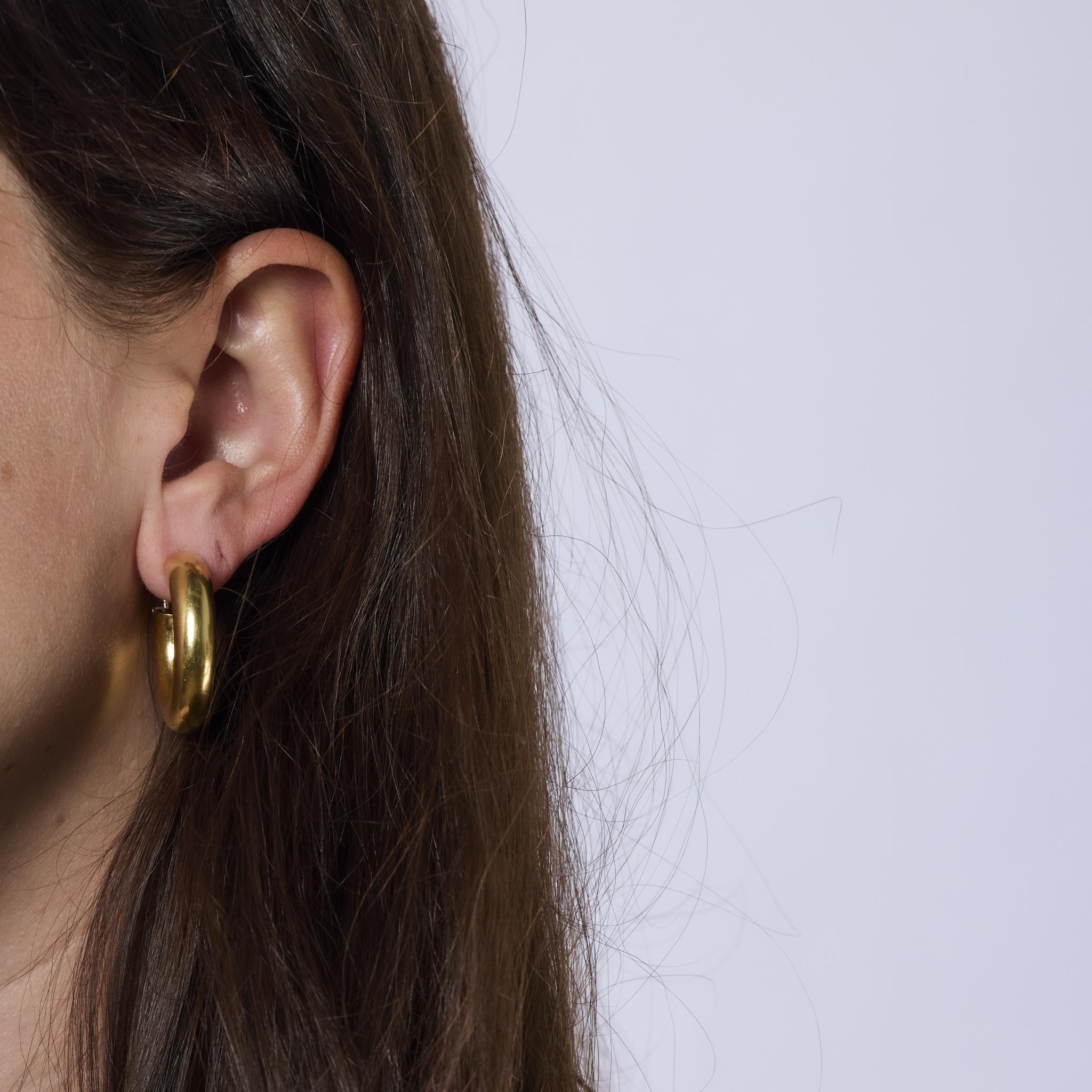 These bold vintage Italian earrings are crafted in glowing 18k yellow gold with a sculptural, statement-making design. A luxurious reflection of the iconic 1980s style and craftsmanship.