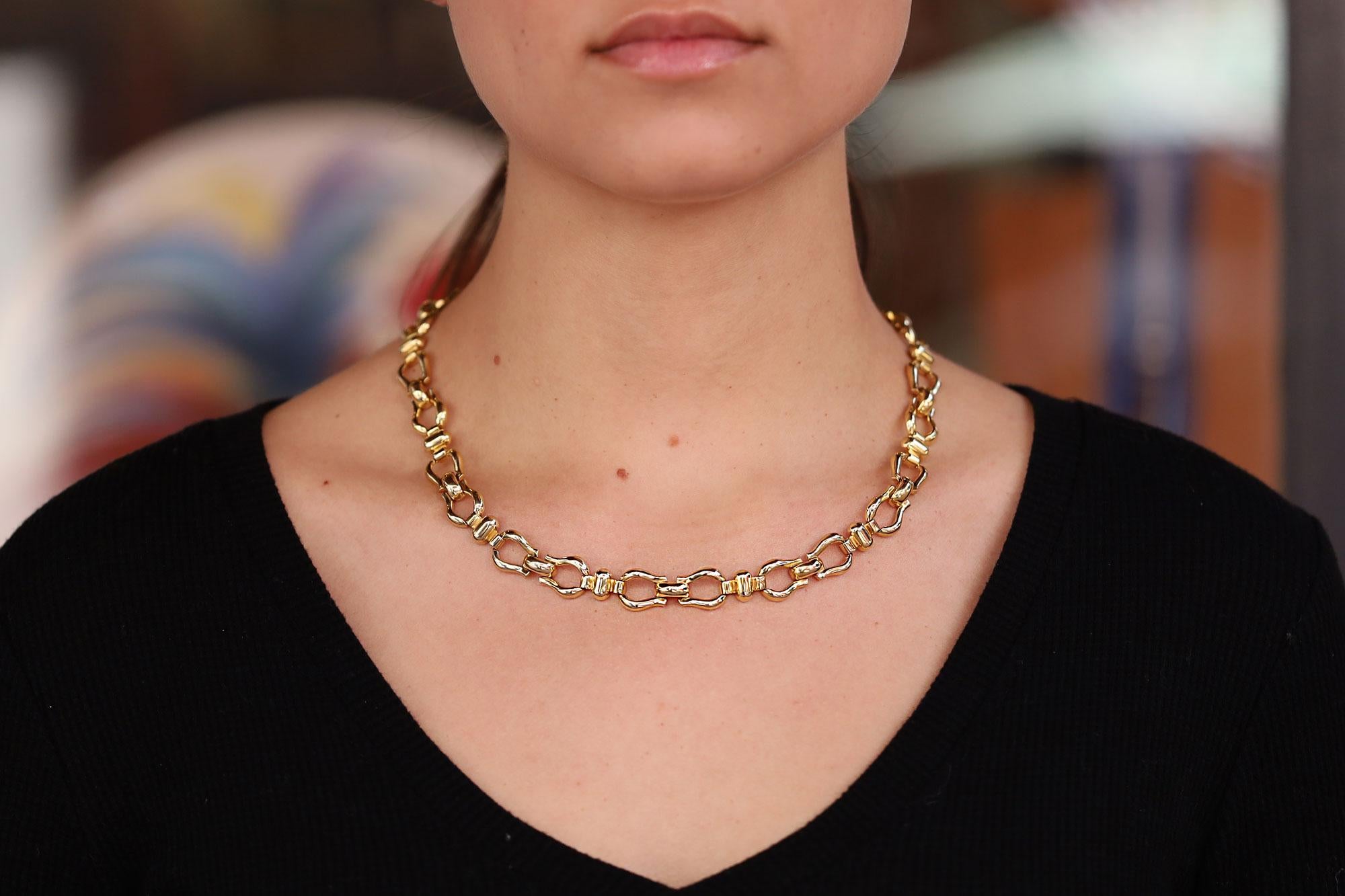 A weighty and wonderful vintage Italian 18 karat yellow gold horsebit collar necklace. Former property of a Beverly Hills estate jewelry collection, this equestrian inspired link necklace drapes gracefully on your neck with a luxurious feeling. At