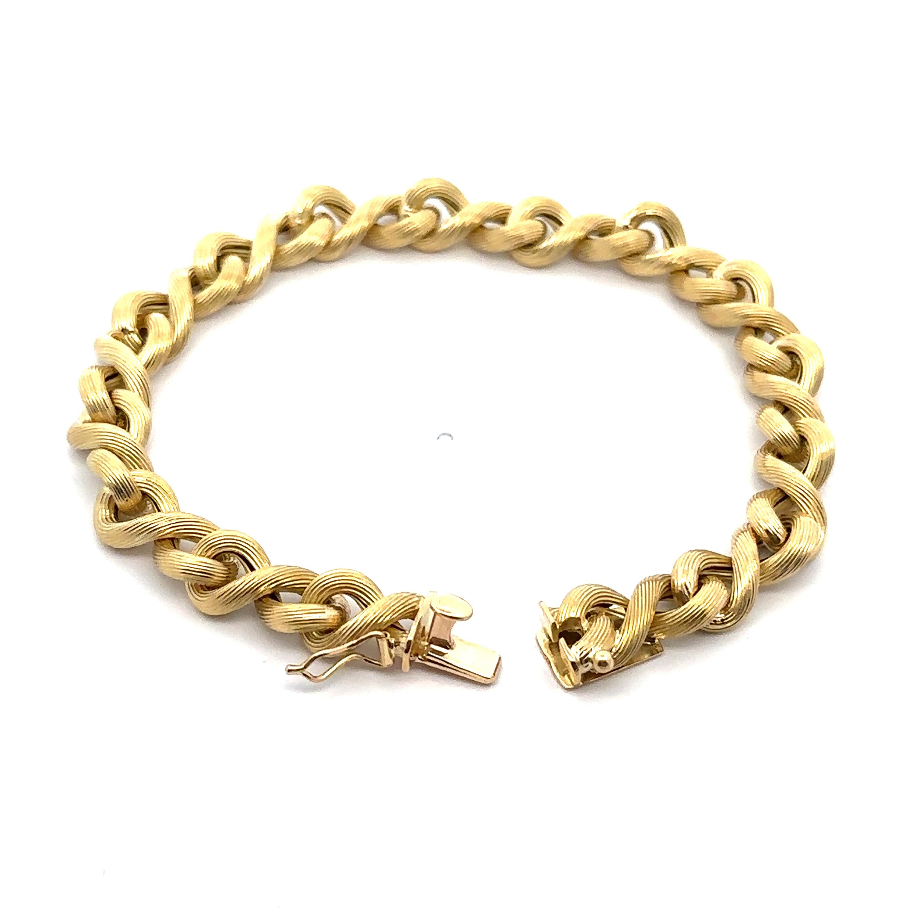 Material: Solid 18k Yellow Gold - Hollow Design
Weight: 14.62 Grams
Chain Type: Infinity/ Figure 8 links
Chain Length: Will comfortably fit up to 7” wrist (fitted on wrist)
Link Width: 7.5mm 
Closure: Push Clasp w/ Safety Latch
Condition: Polished,