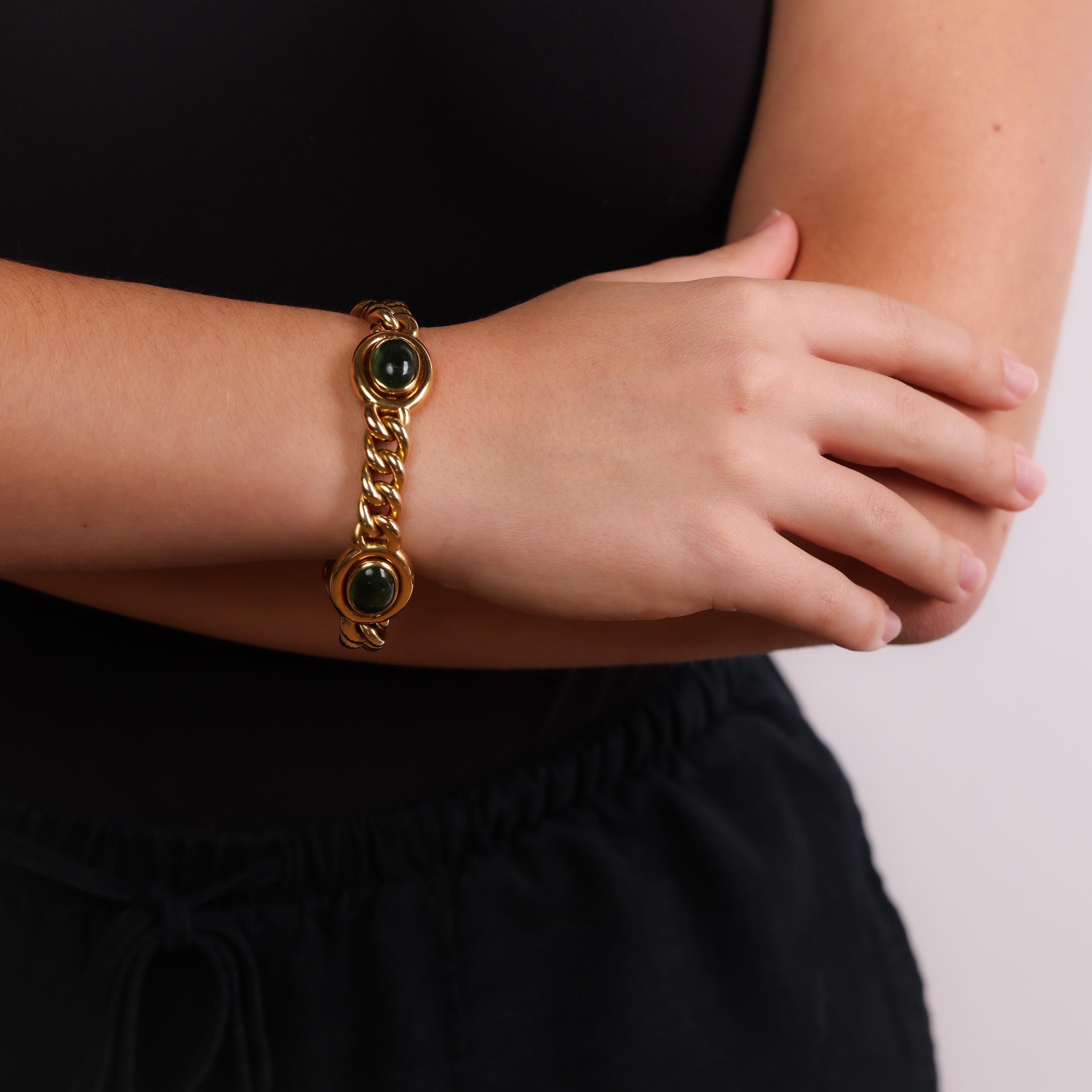 This vintage 18k yellow gold bracelet showcases three luminous cabochon-cut green tourmalines, offering a bold yet timeless design with exceptional craftsmanship from Italy in the 1980s.

Center Stone: 3 cabochon cut green tourmalines
Metal: 18K