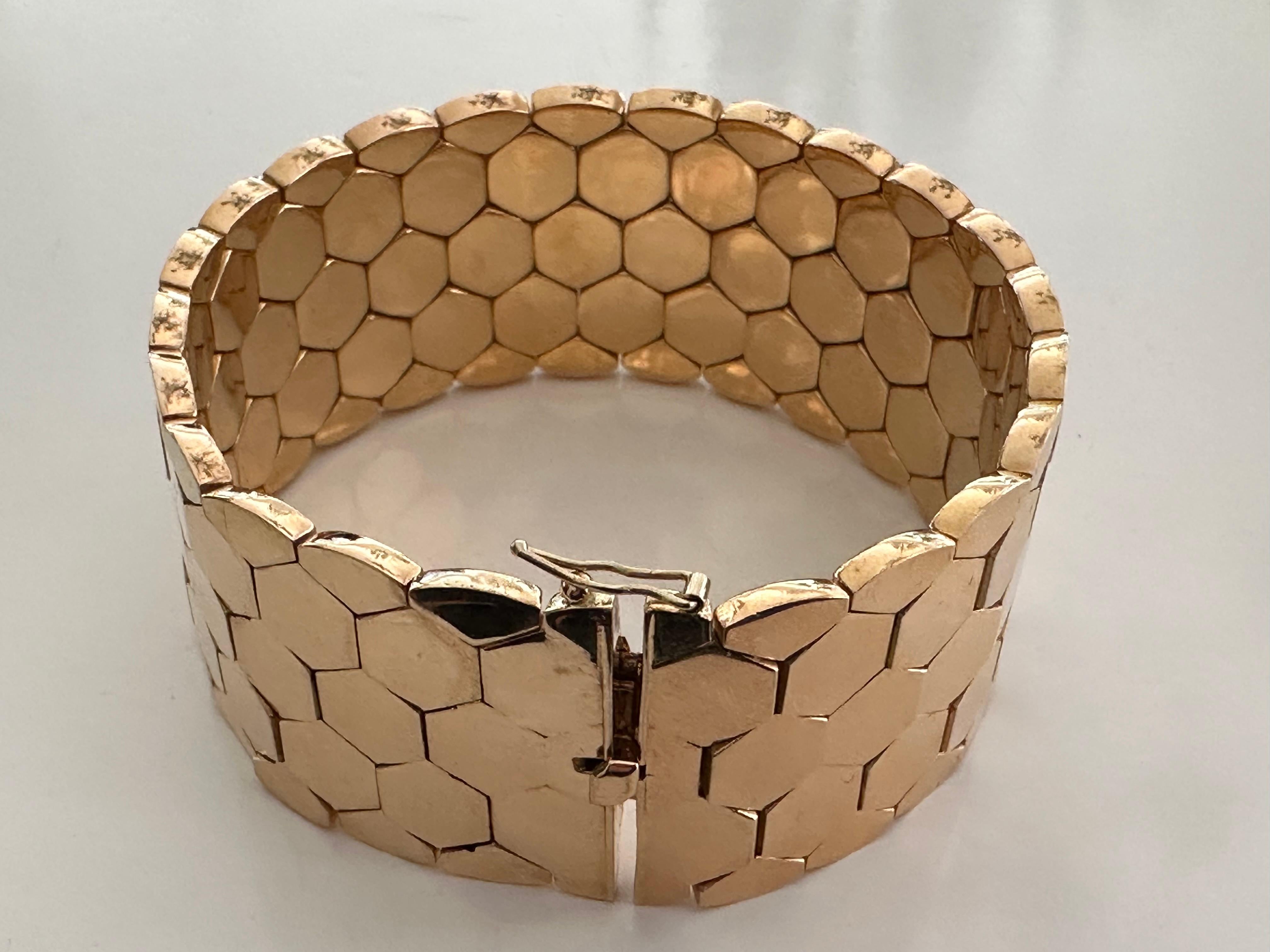 Crafted in Italy in the 1970s, this lustrous 18K yellow gold honeycomb link bracelet measures eight inches long and one inch wide and represents the bold, statement pieces of the late 20th century. The bracelet can be resized. 
