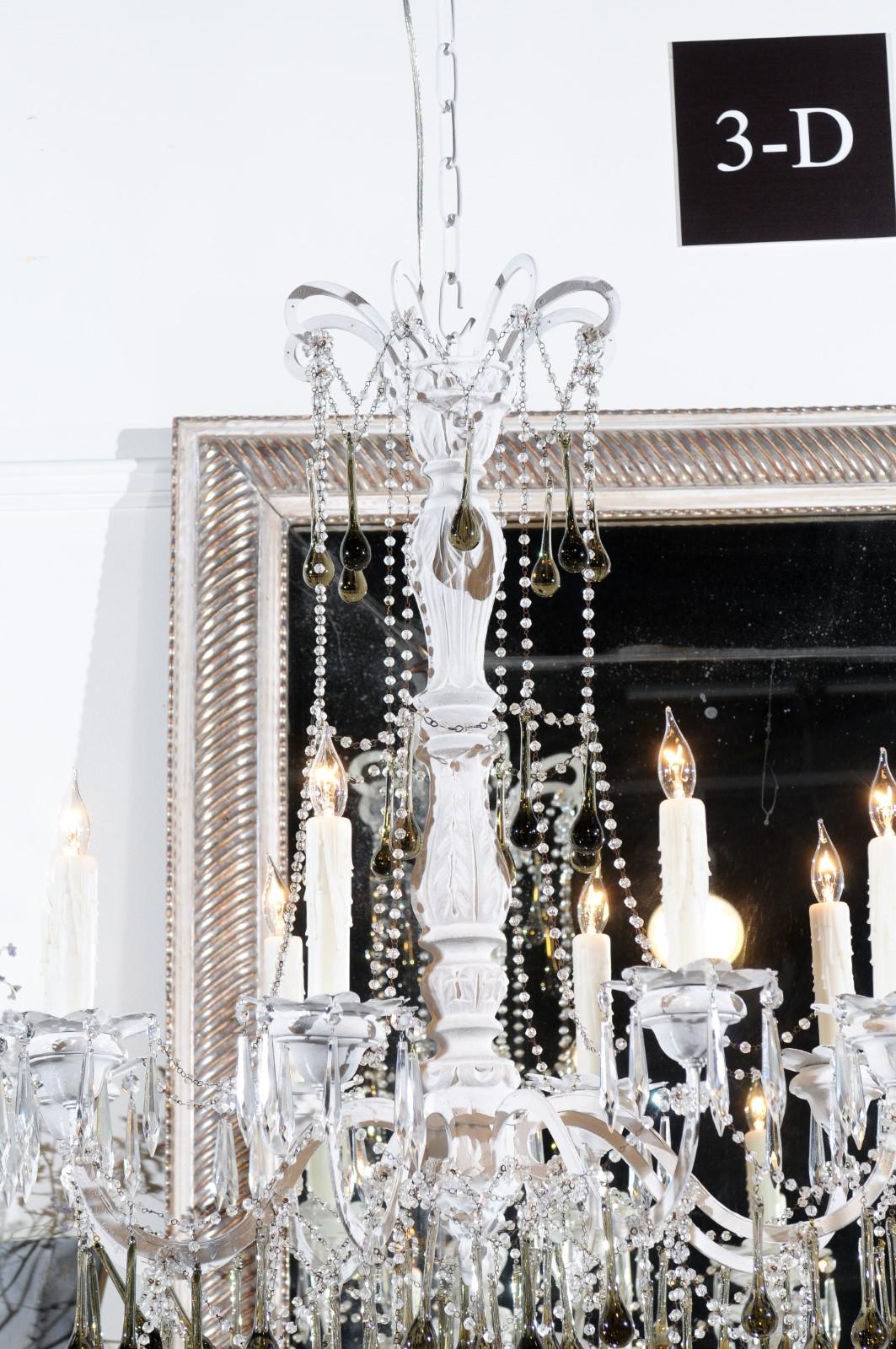 A vintage Italian eight-light crystal chandelier from the mid 20th century, with olive teardrop prisms, painted wood altar stick and iron arms. Born in Italy during the 1960s, this crystal chandelier features a central painted wooden altar stick,