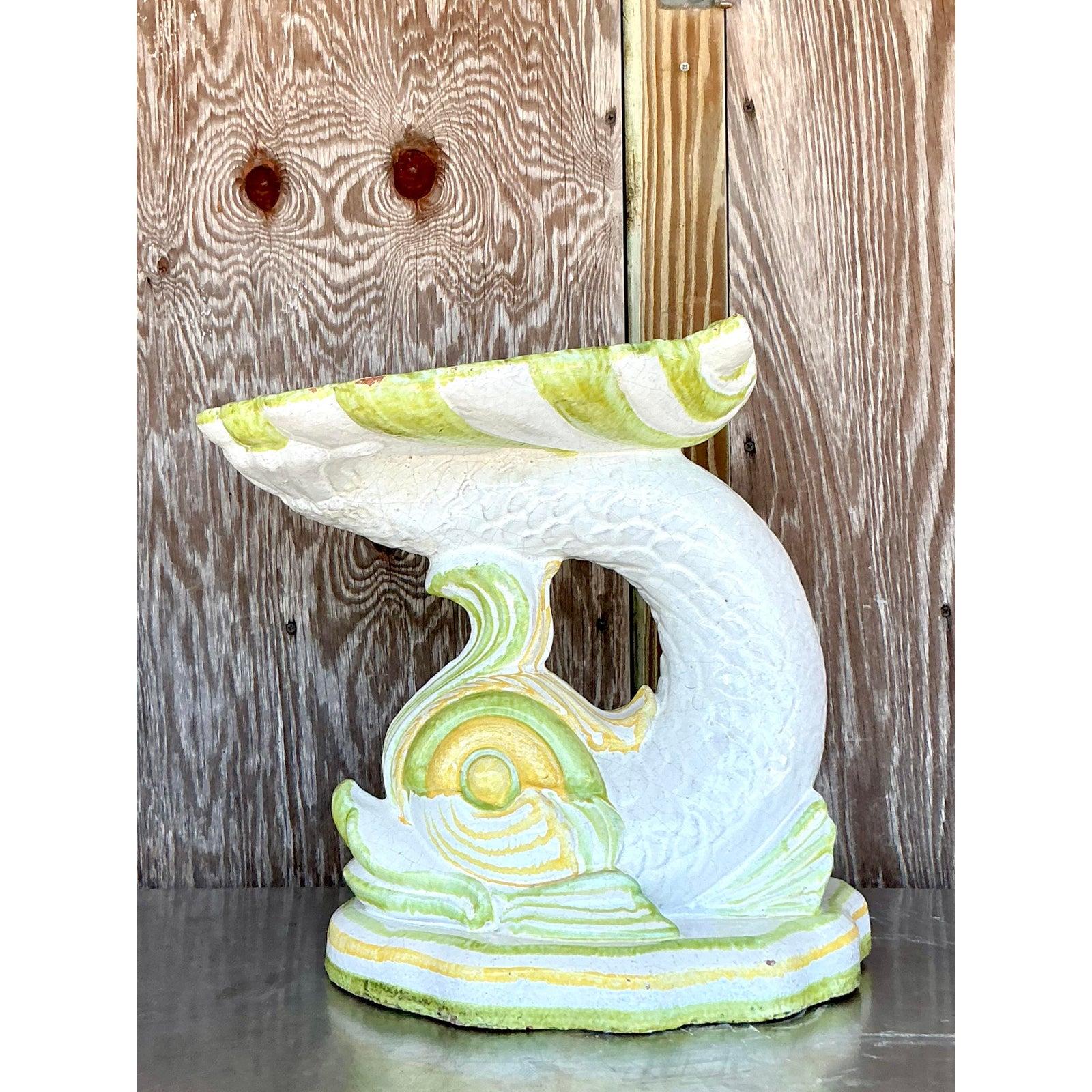 Capture the fantastic spirit of a seaside Italian grotto with this magnificent vintage dolphin pedestal. Masterfully hand-crafted in Italy from glazed terracotta, this piece is a true work of sculptural art. It features a stylized dolphin or