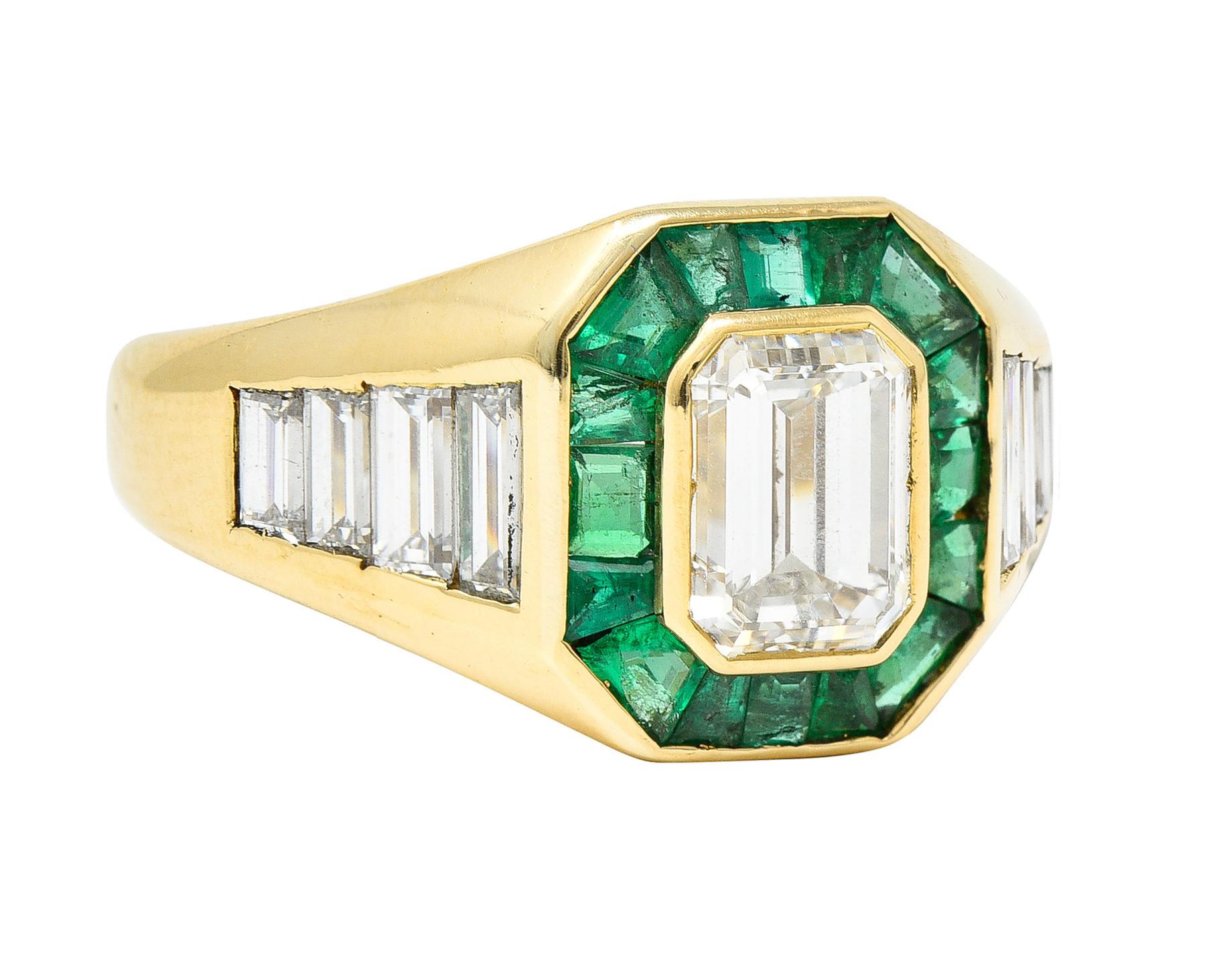 Gold band ring centers an emerald cut diamond weighing approximately 1.15 carat - H color with VS1 clarity

Surrounded by calibrè cut emeralds that weigh in total approximately 0.55 carat

Vividly green in color and semi-transparent with natural