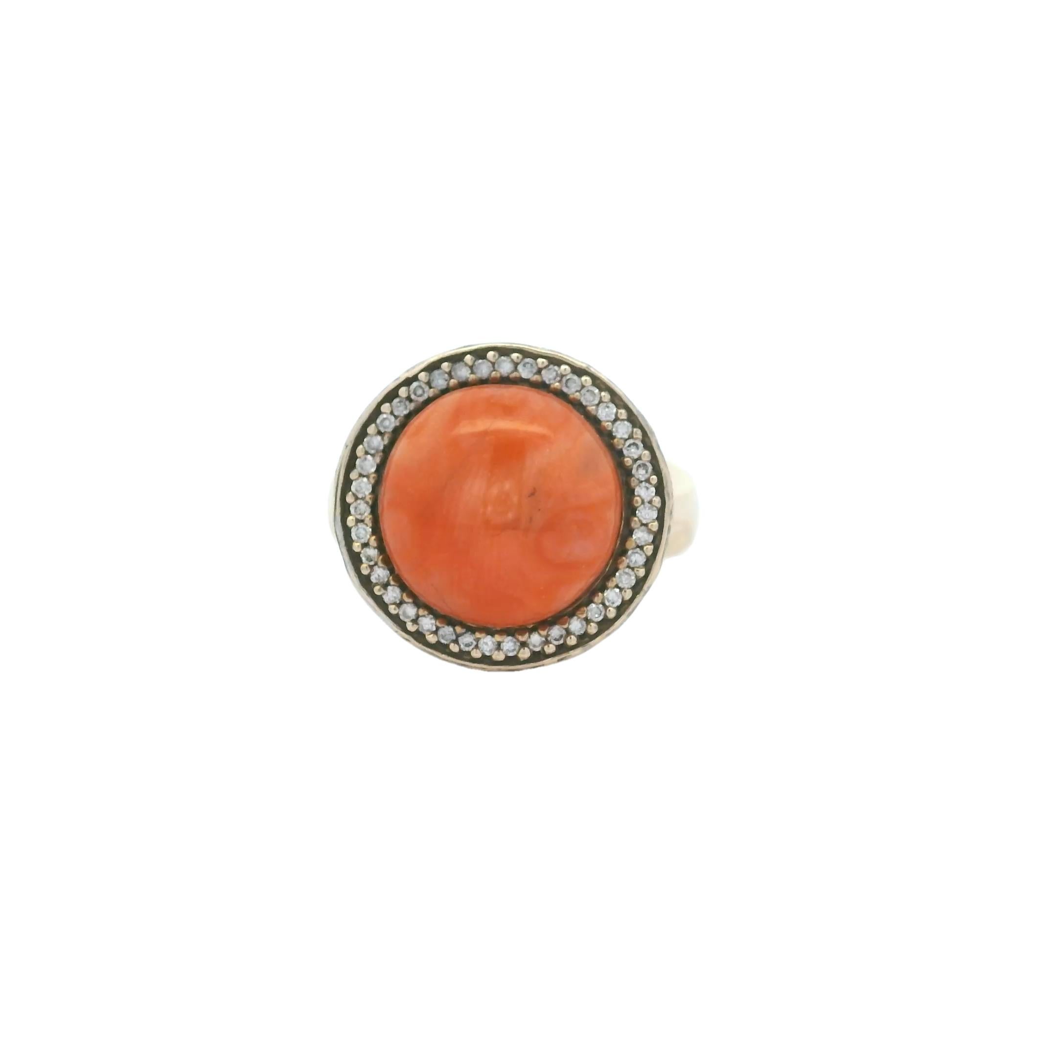 Dieser italienische Vintage-Ring ist eine anmutige Verbindung aus Wärme und Brillanz. Er zeigt einen leuchtenden Korallencabochon von 5,00 Karat, der von einem Halo aus weißen Diamanten von etwa 1,00 Karat umgeben ist. Die reichhaltige, lachsfarbene