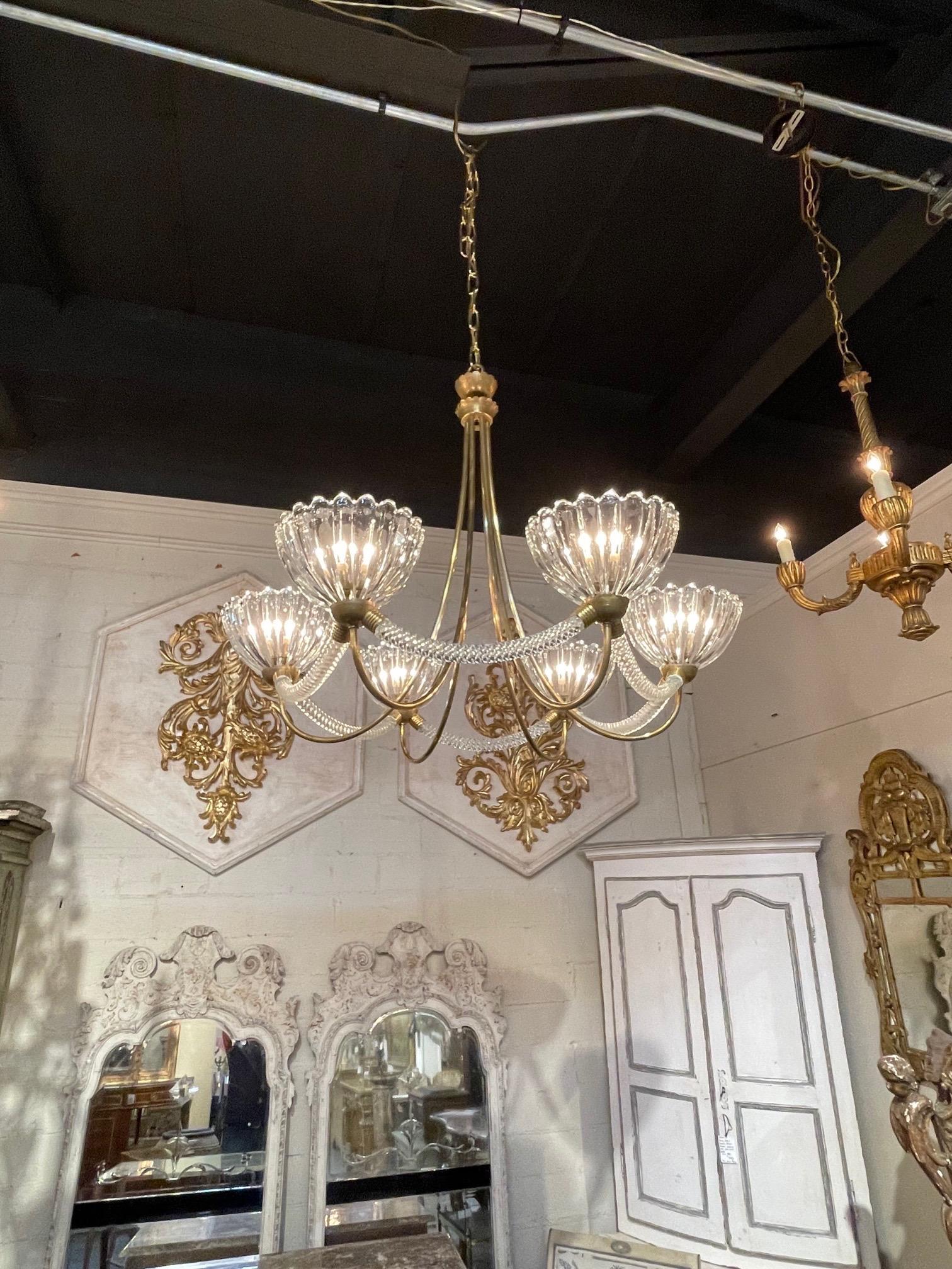 Exquisite vintage Italian glass and brass chandelier with 6 lights by Barovier and Toso. Beautiful curved base and along with the glistening glass are so pretty!