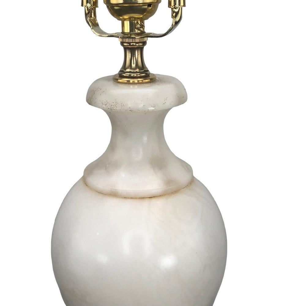 Vintage Italian Carved Alabaster Urn Form Lamp. Beautiful white alabaster stone with very little veining makes it a prized addition to any setting. The urn sits atop a tall square plinth base giving the lamp a very graceful appearance. Newly wired