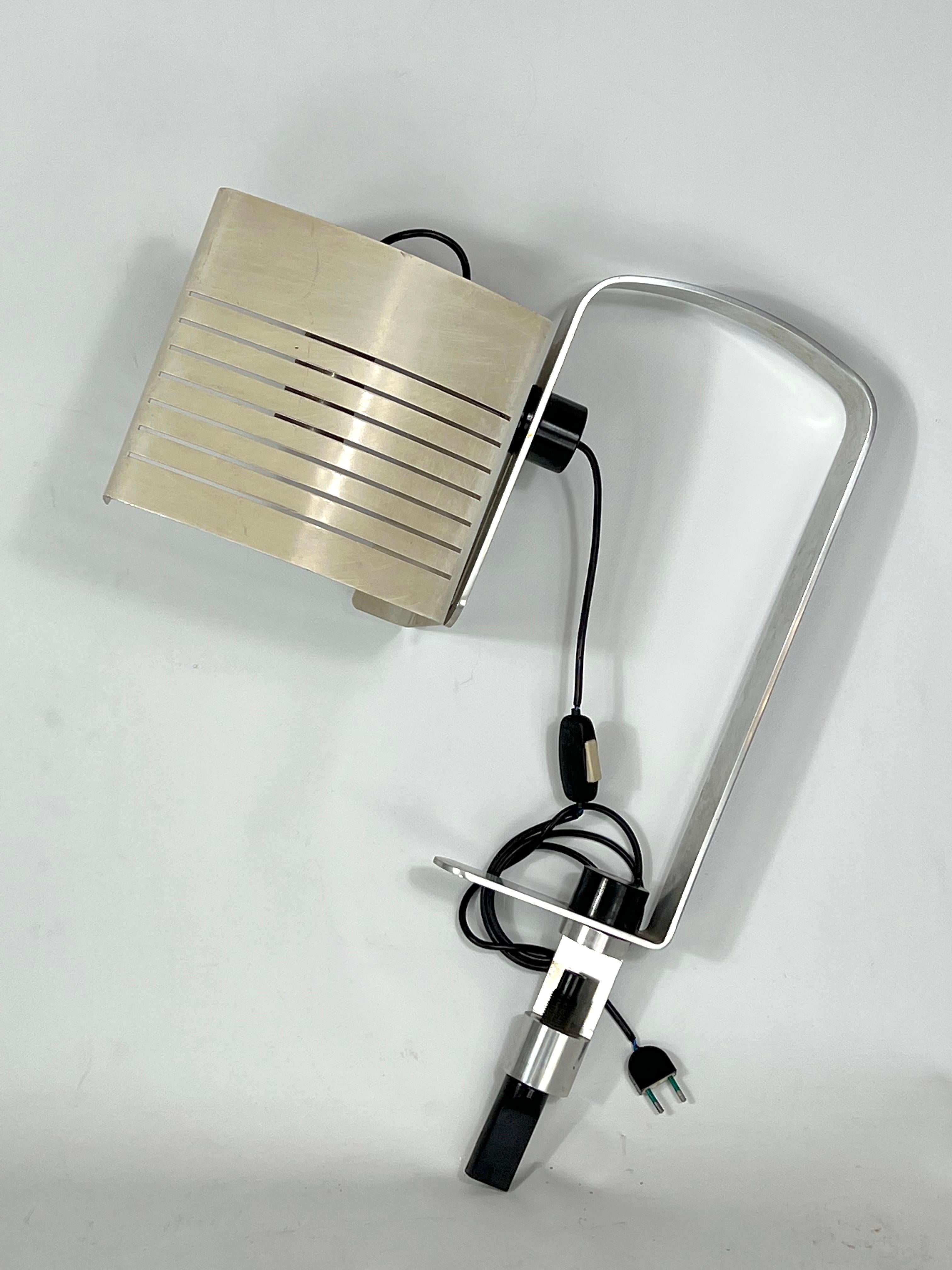 Reminiscent of Joe Colombo style for Oluce, this desk lamp is made from aluminum, plastic and lacquer and it is in original vintage condition with trace of age and use. Full working with EU standard, adaptable on demand for USA standard.