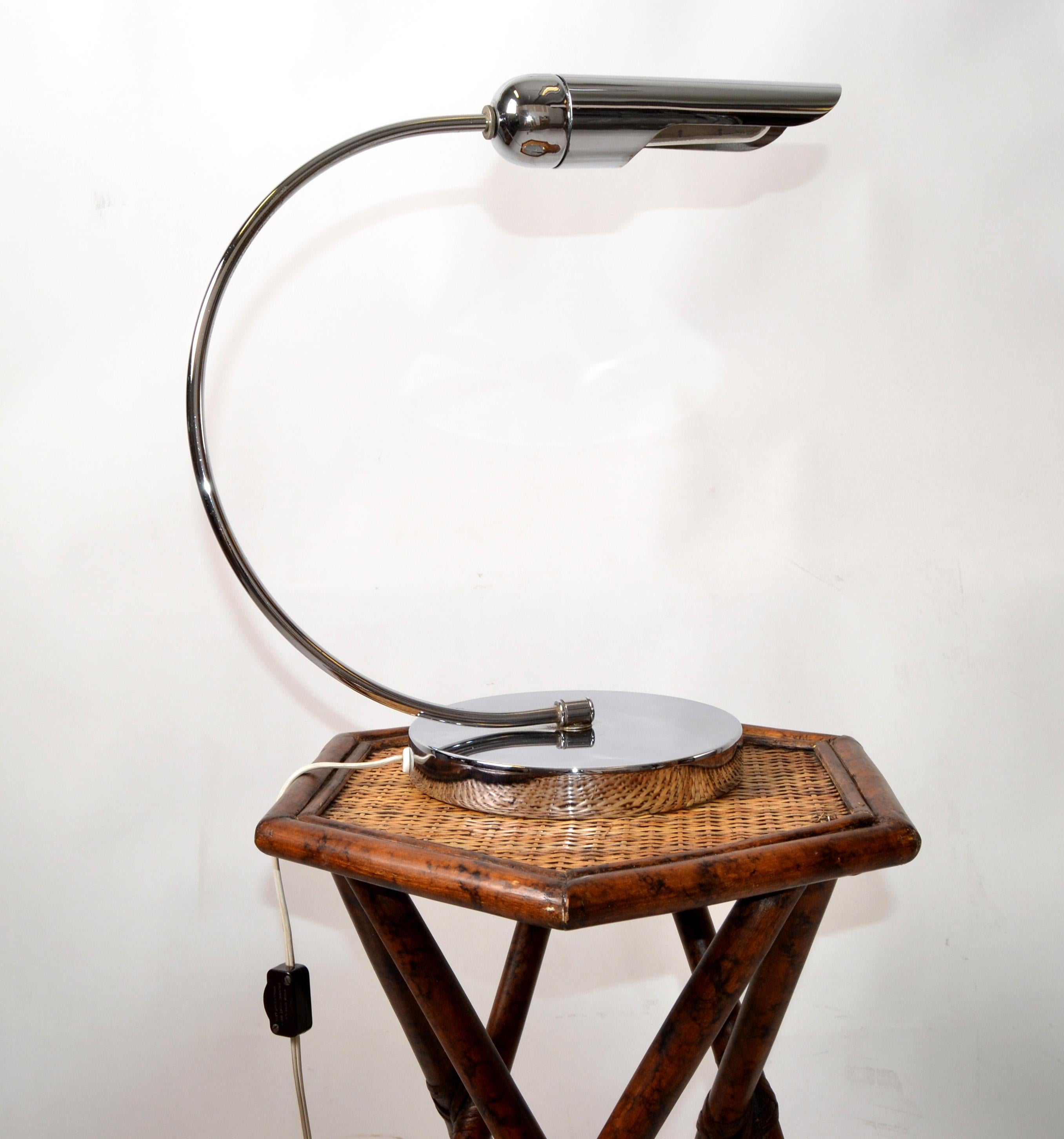 Italian 1980 Mid-Century Modern chrome & steel desk lamp with swing arch stem. 
The round base has a felt cover and the desk lamp takes a single fluorescent tube bulb.
In perfect working condition and shows only light patina to the Top.
Practical