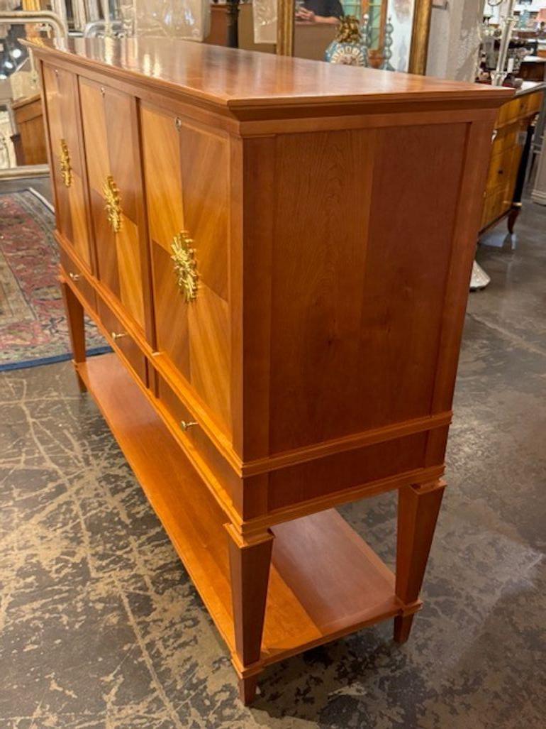 The Vintage Italian Art Deco Design Bookmatched Cherrywood Cabinet is a stylish and unique piece of furniture that exudes a retro charm. Crafted from high quality cherrywood, this cabinet features a bookmatched design that adds a touch of