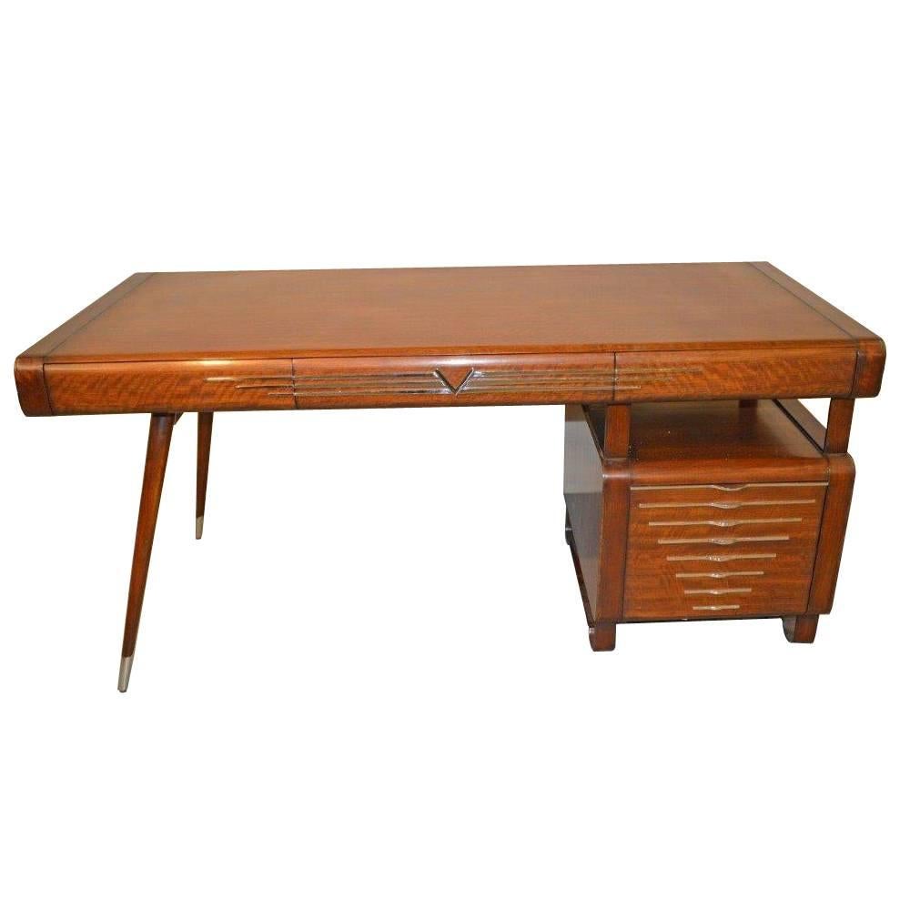 A single pedestal Italian Art Deco style desk with chrome accents in the style of Gio Ponti. This desk features a floating writing with three pull-out drawers and the pedestal has one large filing cabinet. The legs are splayed with chrome caps, and