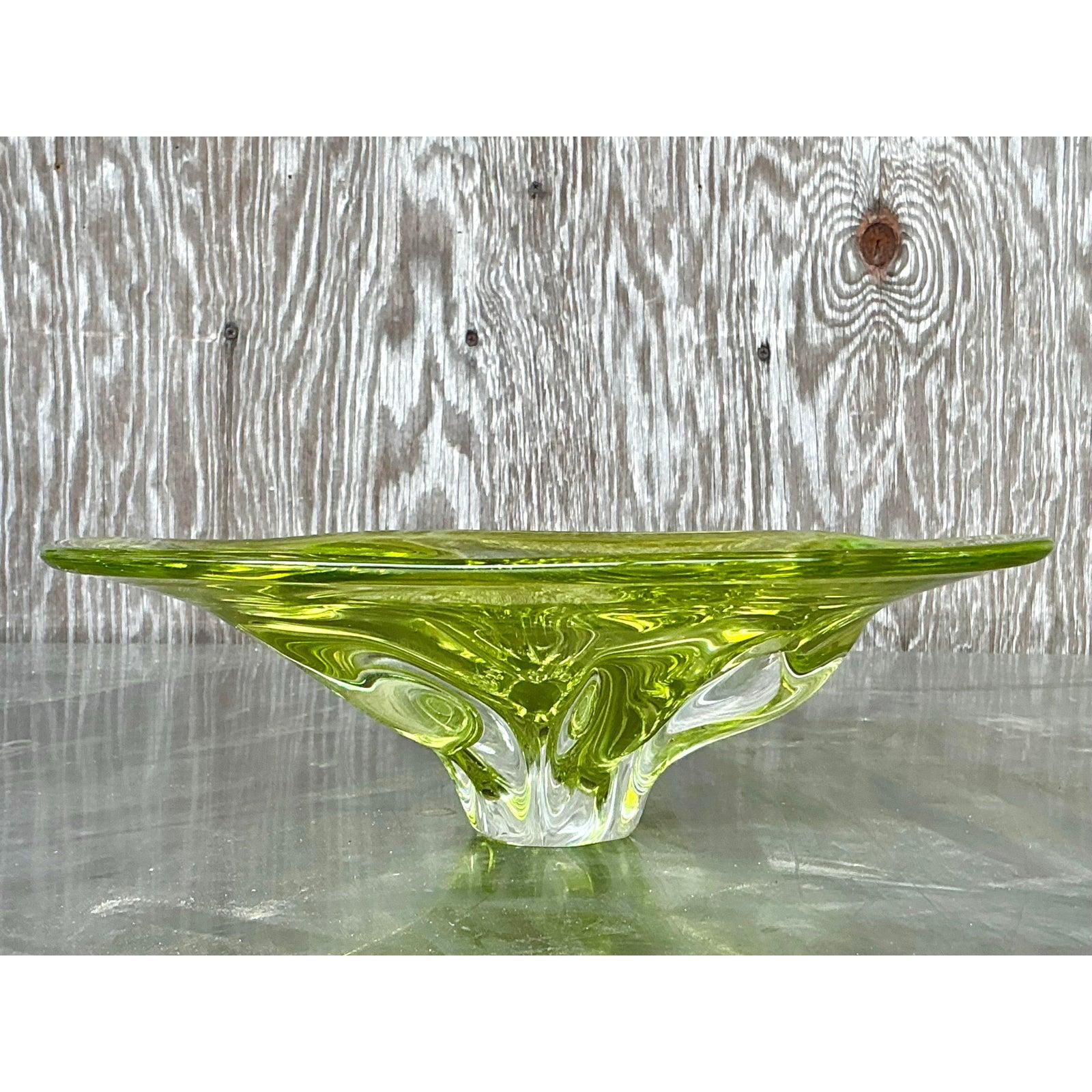 Add a touch of elegance to your décor with this vintage Italian art glass bowl, inspired by the masterful craftsmanship of Murano. Featuring a striking organic shape and a luminous chartreuse green hue, this sculptural bowl reflects light