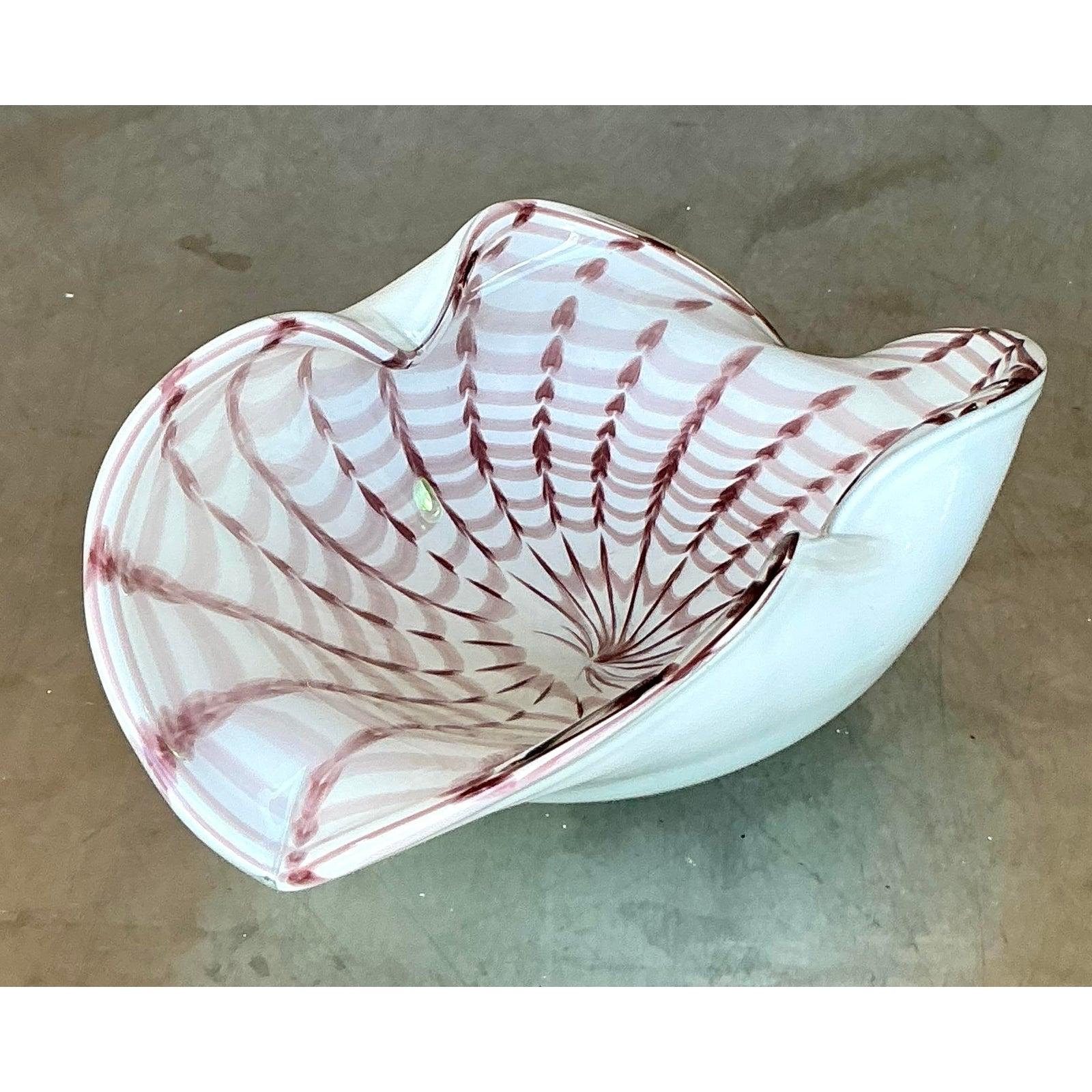 Capture the essence of Italian artistry with this exquisite vintage art glass bowl, crafted in the renowned style of Murano glassmakers. The bowl features a captivating organic, scalloped form, possibly employing the 