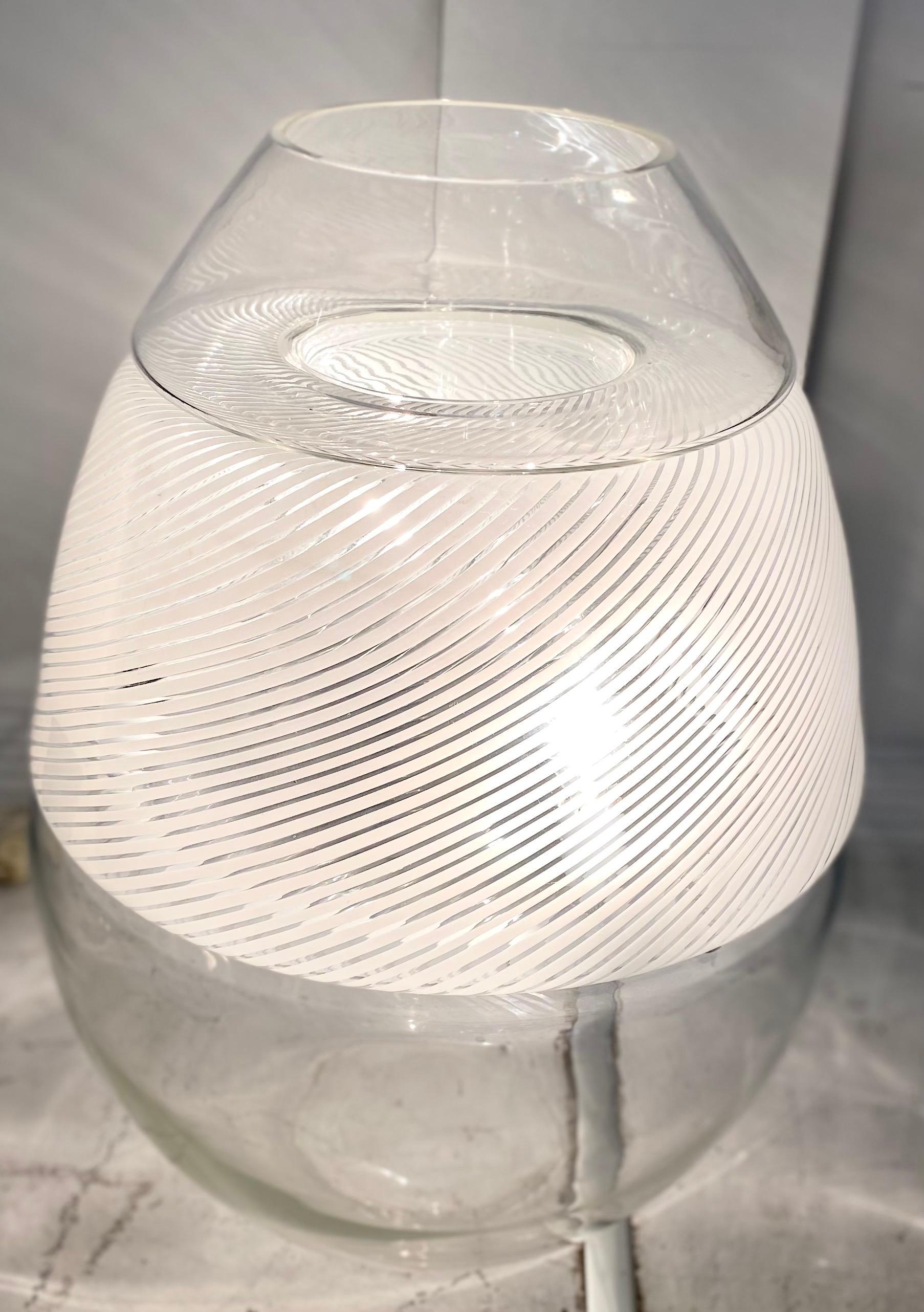 Incredible and rare large mid-century glass Arte Vetro Murano egg lamp. It is a stack of three separate blown glass pieces. The center piece is swirled glass with the lighting apparatus. The top and bottom are a solid clear glass. Made by Vetri