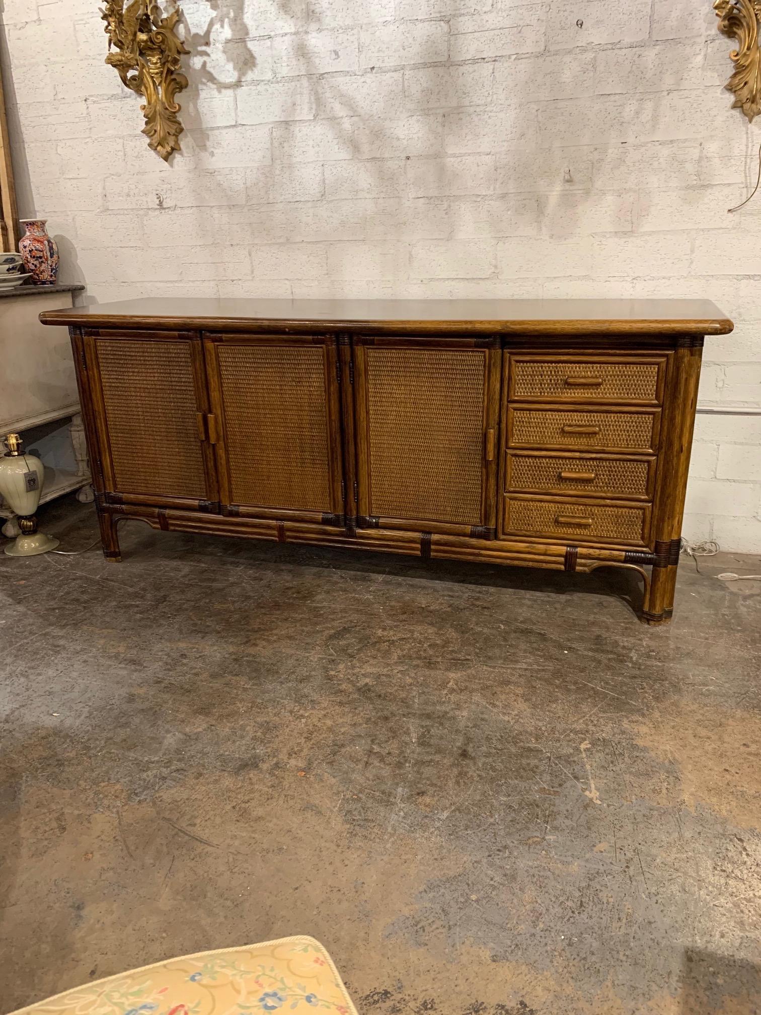 Nice quality Italian vintage bamboo credenza. Nice finish on the top and tons of storage with drawers and shelves inside. Creates an interesting vibe!