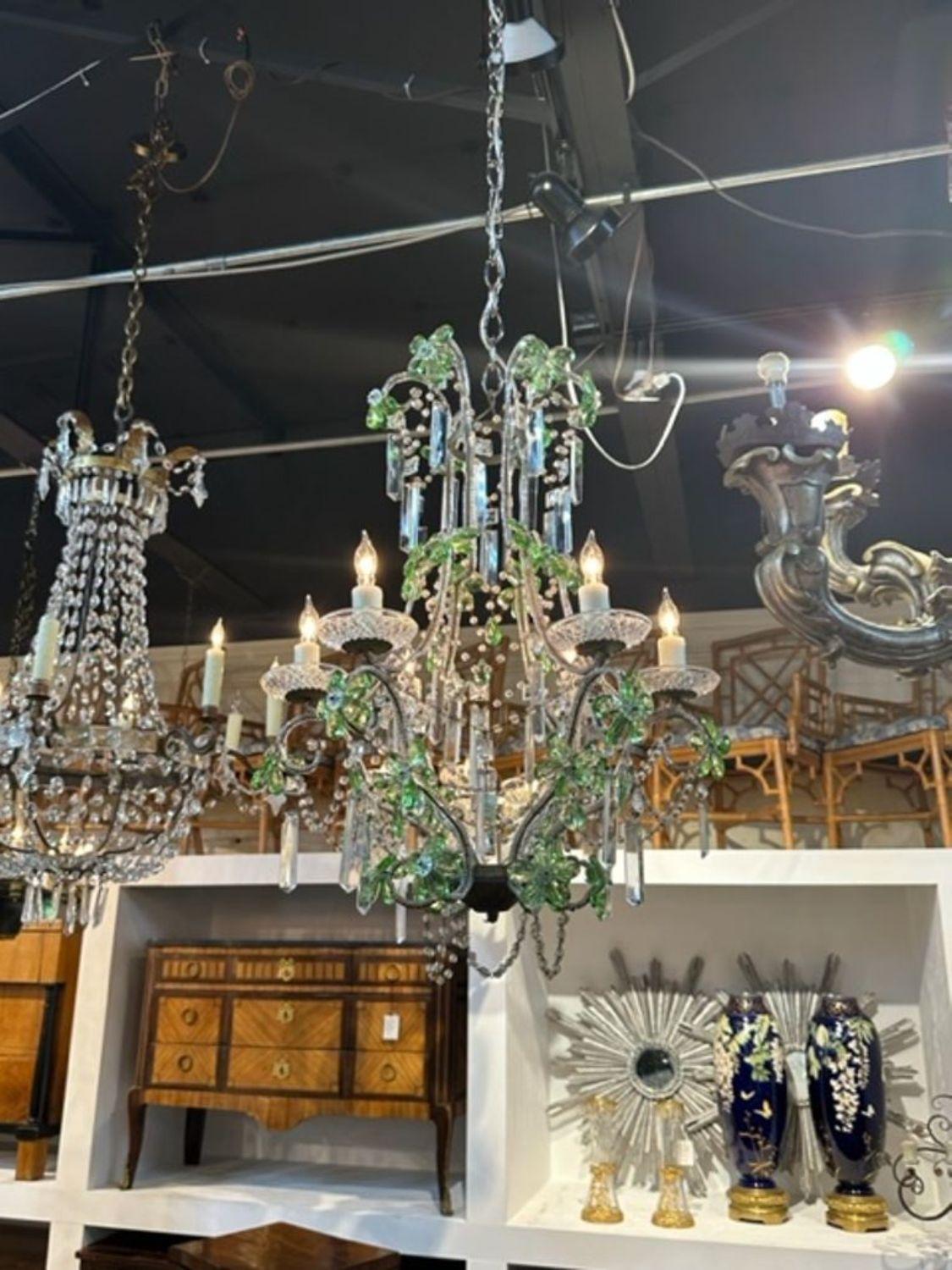 Beautiful vintage chandelier with beads and green prisms, some in the shape of flowers. Makes an elegant statement!