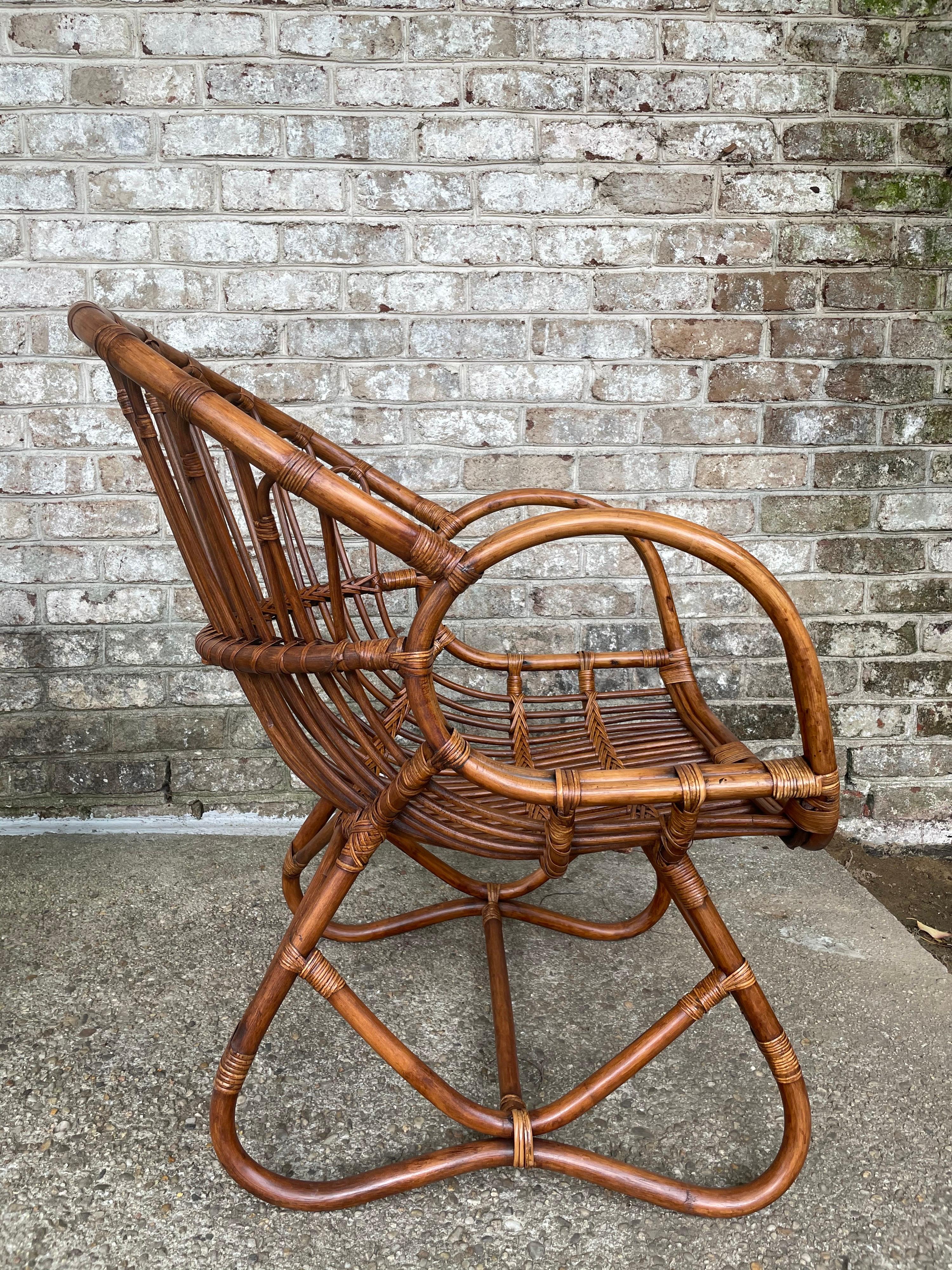 These wonderful vintage bent bamboo and rattan armchairs are intricately designed. No cushions or lambskin shown is included. Very comfortable as they are and restored to their original beauty.