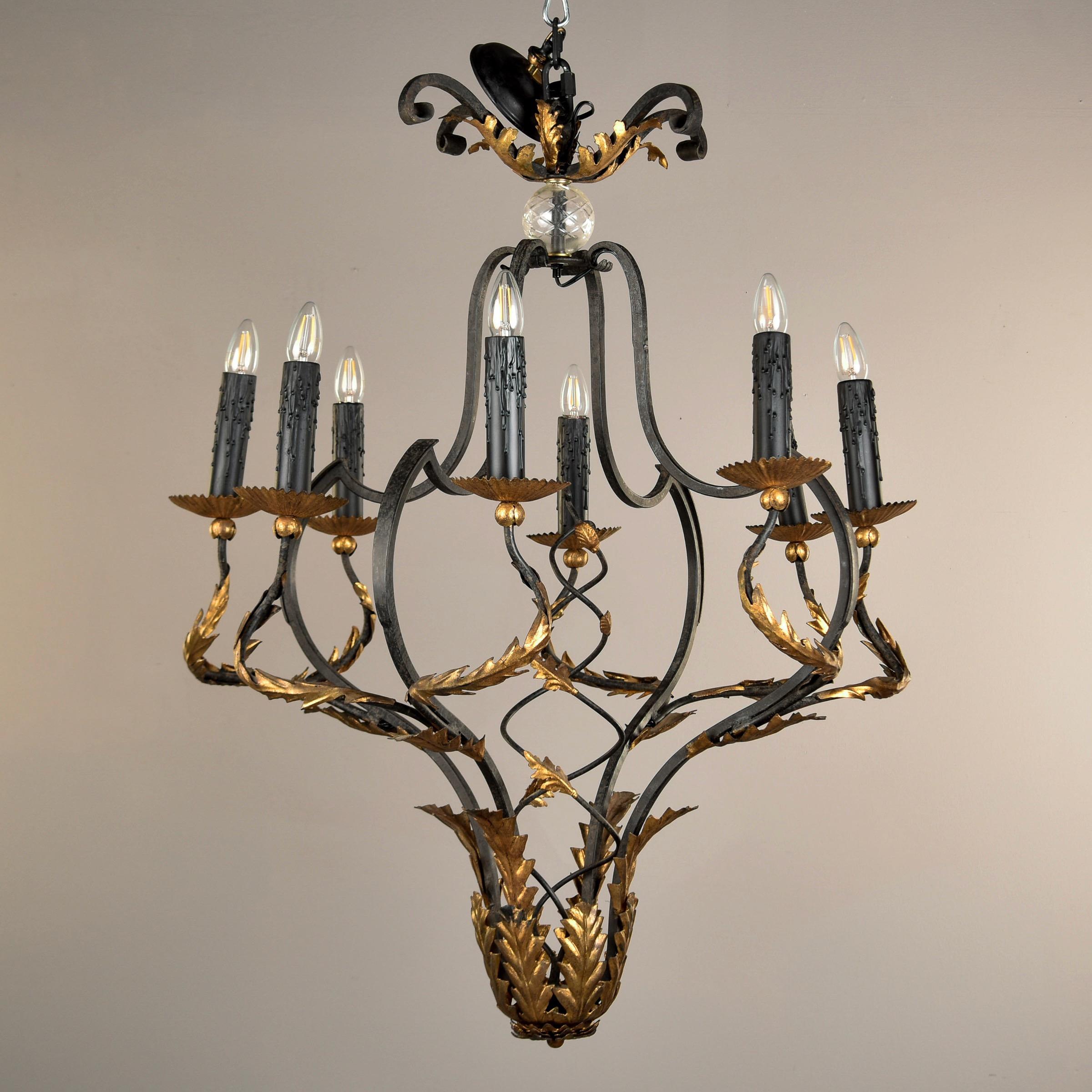 Mid century Italian eight light chandelier has a black iron frame with gilt metal fronds and detailing. Eight candle-style lights with standard sized sockets. Chandelier is 32” diameter and 43” tall. All wiring has been updated for US electrical