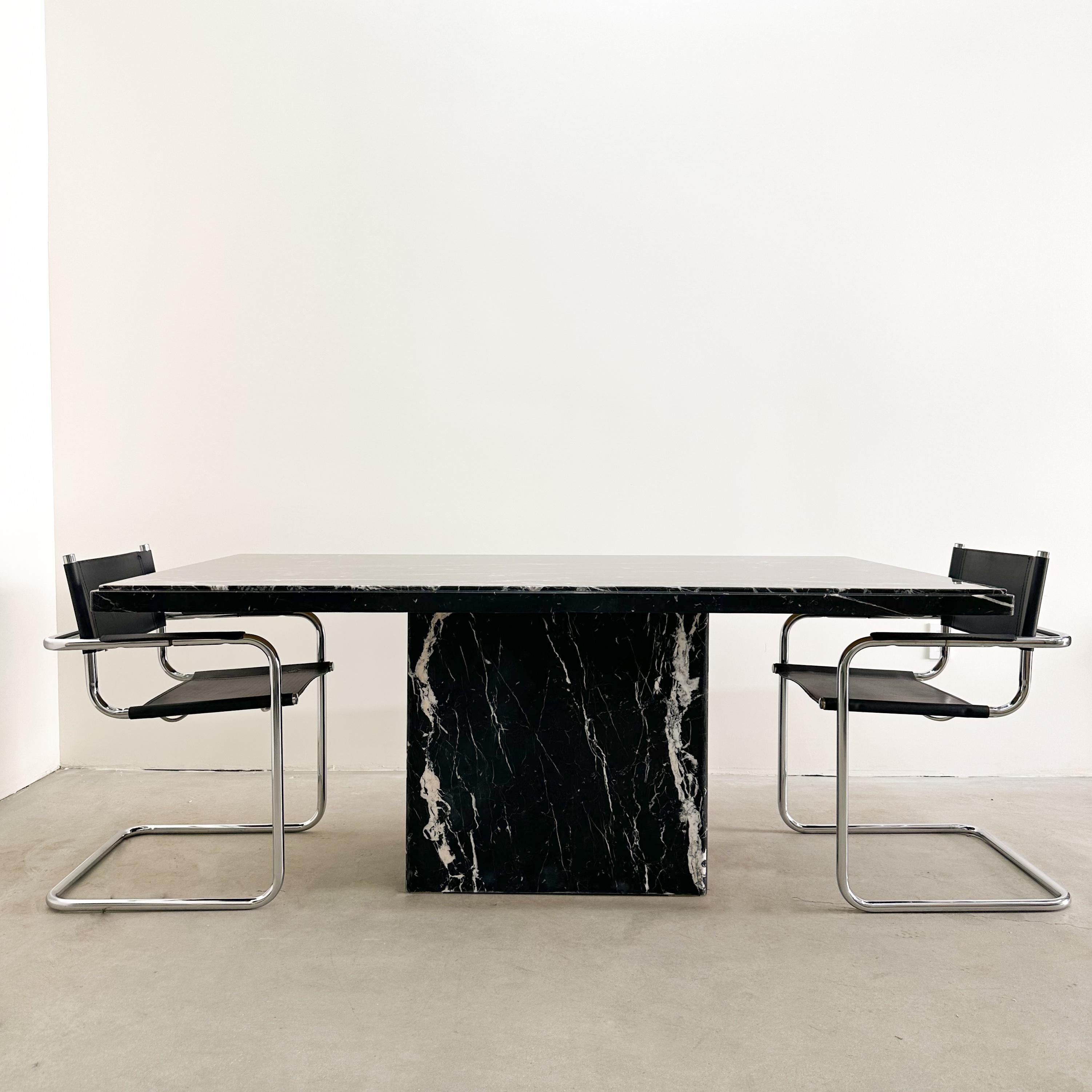 Vintage Italian Black & Off-White Rectangle Marble Dining Table 

Made out of solid Marble stone. It's in two parts. The tabletop rests on the base. 
The table has a shine. (not too shiny) . Very heavy and made well. Seats 6 comfortably and can seat