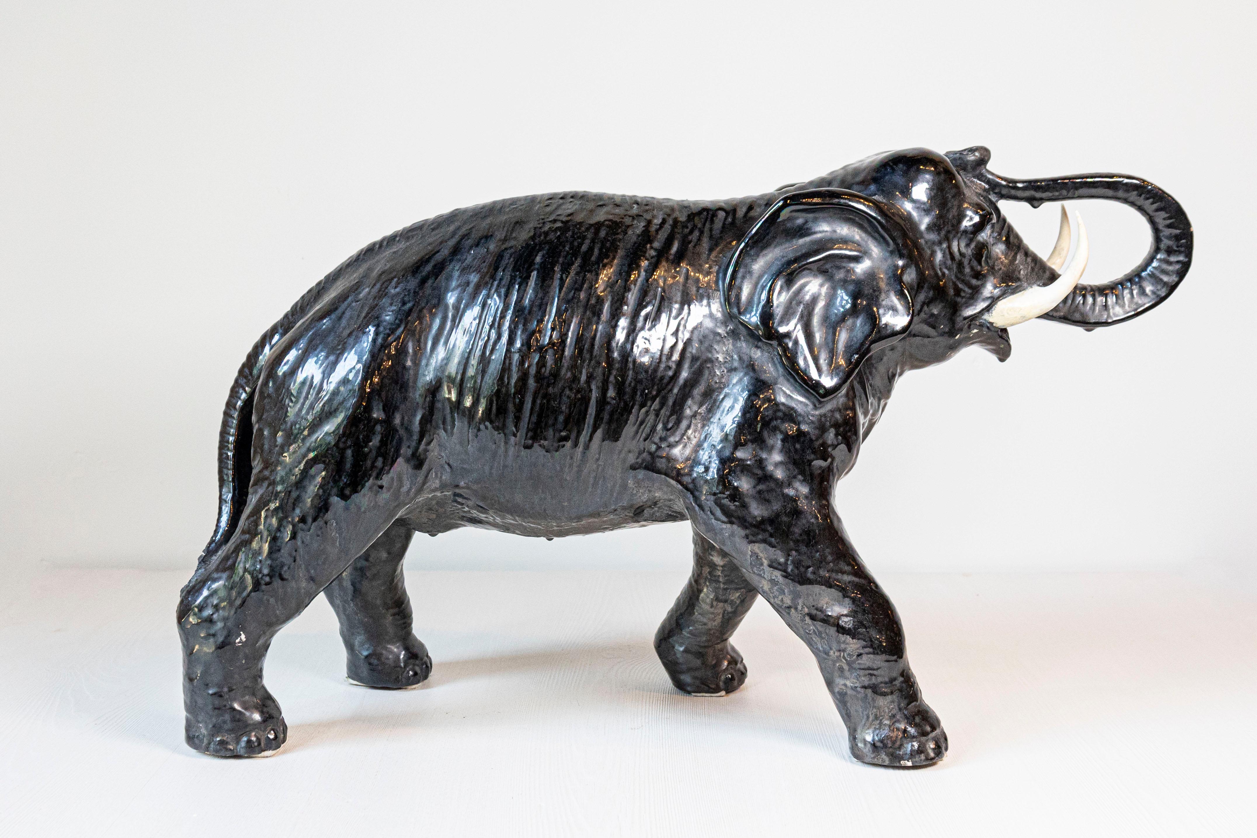 Vintage Italian Black Glazed Ceramic Sculpture of a Walking Elephant, Trunk Up In Good Condition For Sale In Atlanta, GA