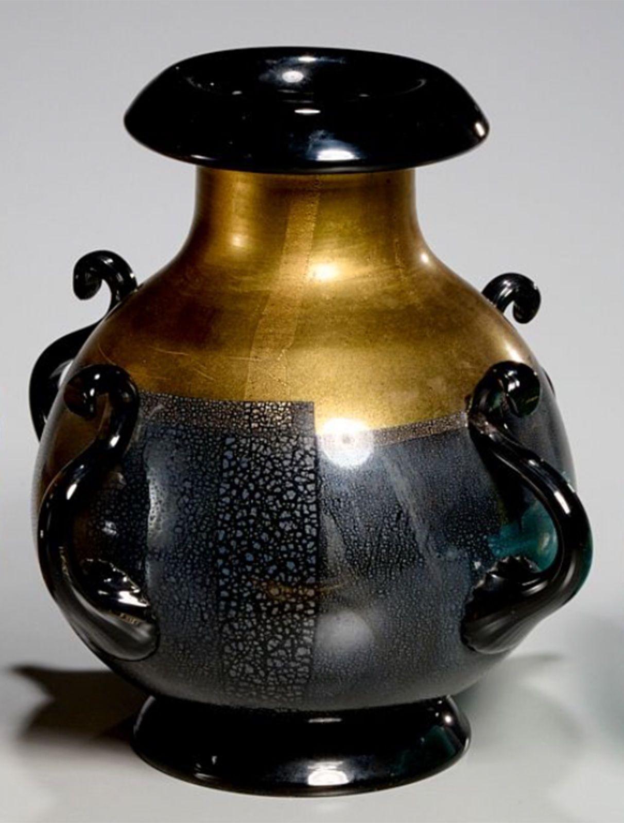 Vintage amphora style vase made of black and gold Murano glass, having four curved handles all around. made in Italy, c. 1970's.
*The piece is not signed by Murano, but information on provenance will be provided upon request.
Dimensions:
9