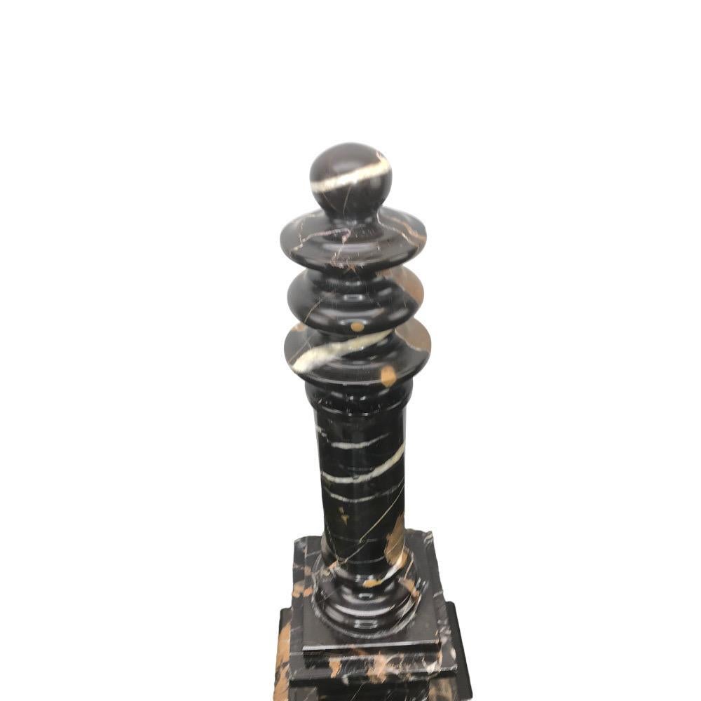 Vintage Italian marble column in black with white and tan veining . The turned column sits atop a square plinth with a stepped base. A nice decorative addition to a desk or a bookshelf.