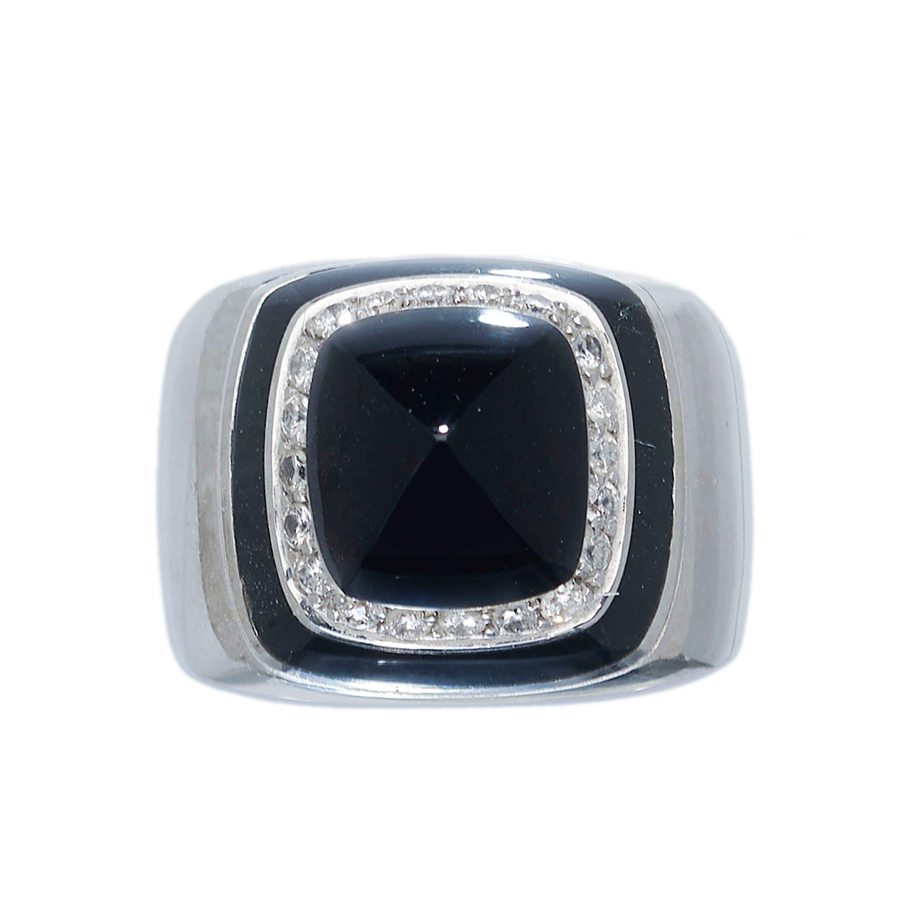 A vintage Italian black onyx and diamond dress ring, set with a square, sugar-loaf shaped, cabochon-cut black onyx, surrounded by a channel of round brilliant-cut diamonds, in grain settings, with a black onyx border, mounted in 18ct white gold with