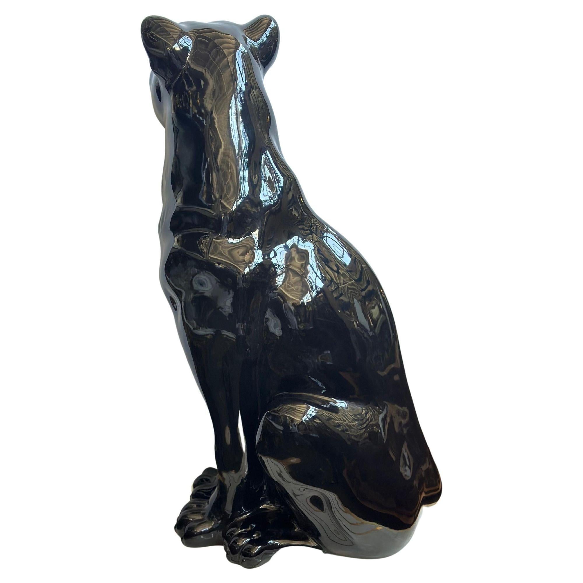 Vintage black panther sculpture adorned with Swarovski crystals on its eyes created in Italy during the 1980's.
The sculpture's glossy black ceramic finish showcases the panther's sleek form, emanating an air of strength and grace while the crystal