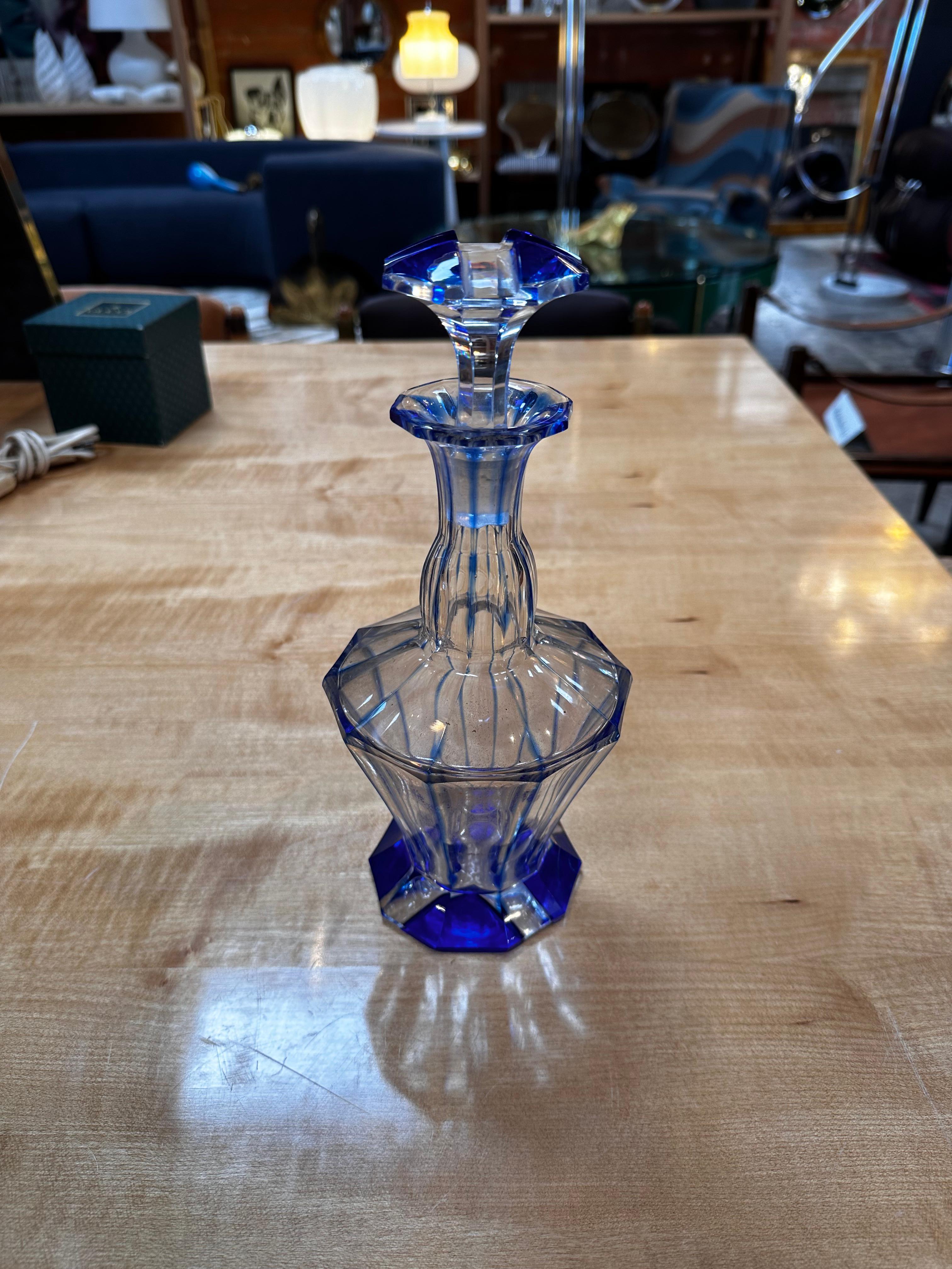 The Vintage Italian Blue Crystal Decanter from the 1960s is a stunning piece of barware that epitomizes mid-century elegance. Crafted from exquisite blue crystal, the decanter boasts a timeless design with clean lines and a touch of retro charm.