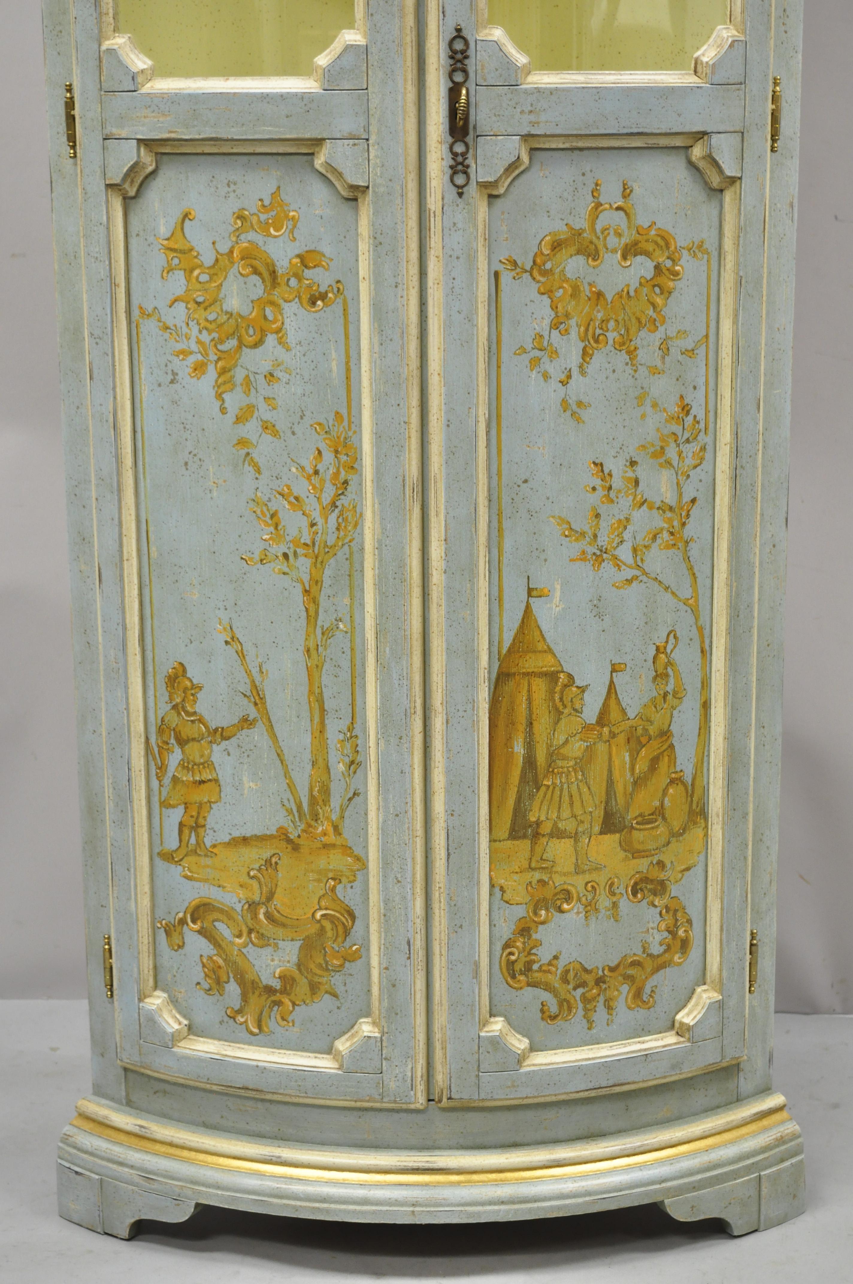 Vintage Italian Venetian blue distress painted tall narrow corner curio china cabinet. Item features tall narrow corner cabinet form, bowed front, curved glass, hand painted scenes, blue distress painted finish, gold accents, 5 wooden shelves, very