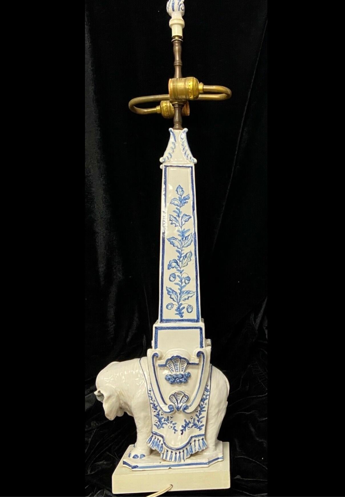 Vintage Italian blue & white mid-century elephant Obelisk table lamp with wooden base. A copy of Bernini's 1667 marble Elephant and Obelisk sculpture in Rome. Blue and white floral and tassel pattern. Excellent condition, no chips or cracks. Double