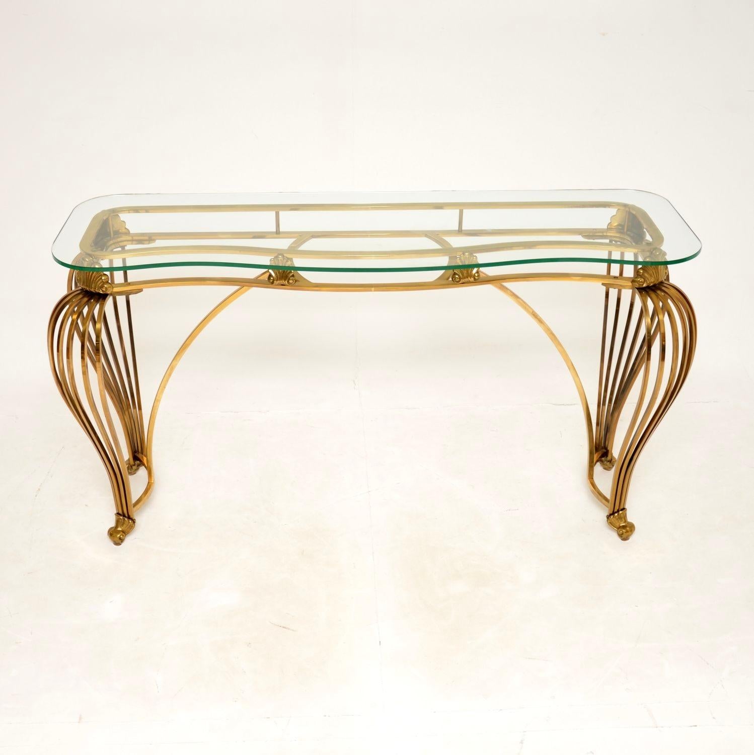 An absolutely gorgeous vintage Italian brass and glass console table. This was made in Italy, it dates from around the 1960’s.

The quality is exceptional, this is extremely well made and very heavy for its size. It is beautifully finished on all
